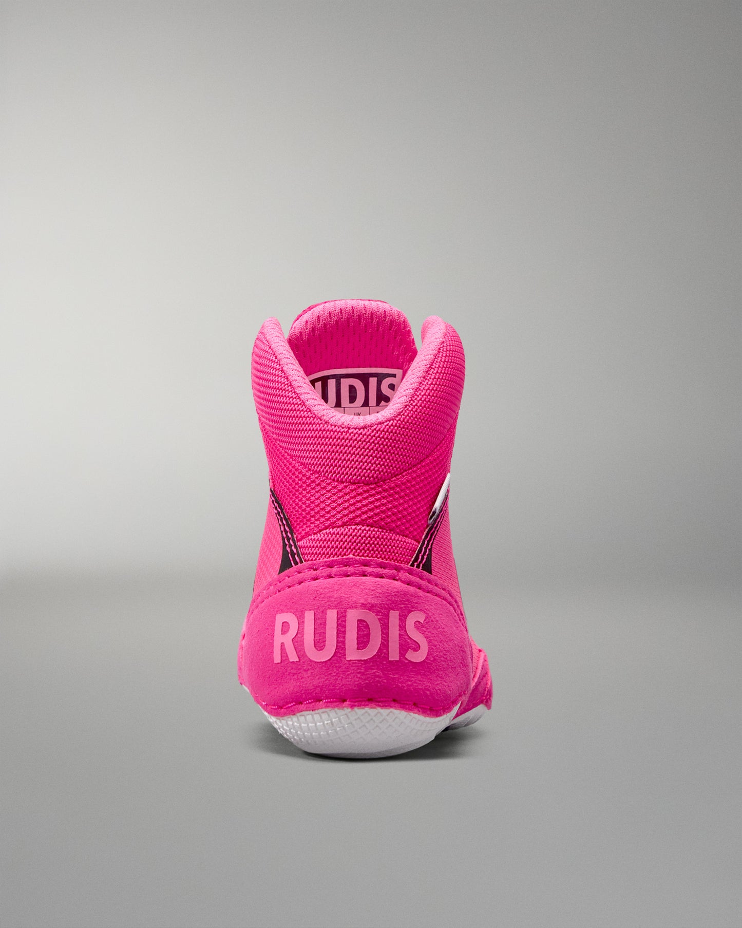 Pink athletic shoe with 'RUDIS' branding on a gray background