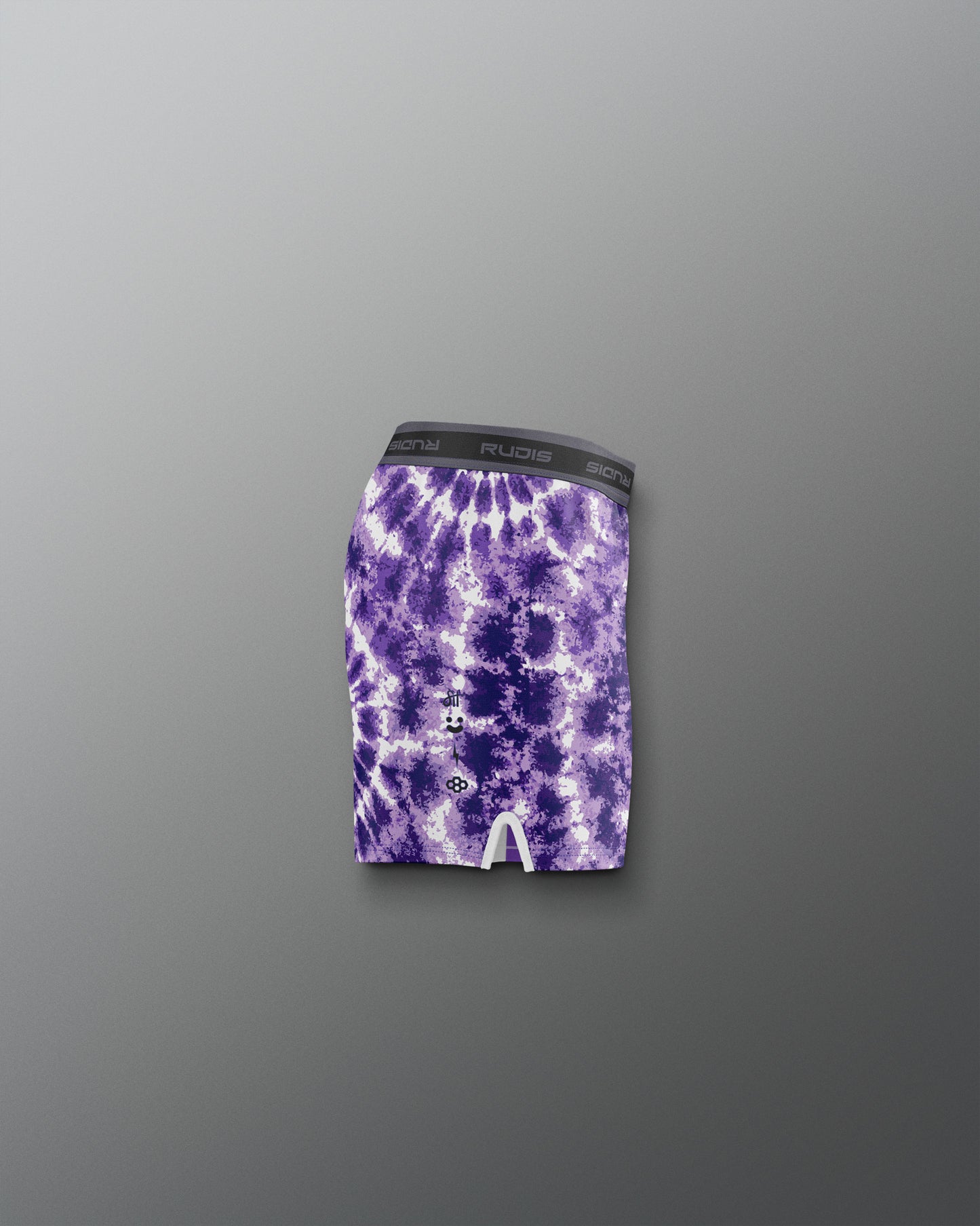 Purple tie-dye athletic shorts on a gray background