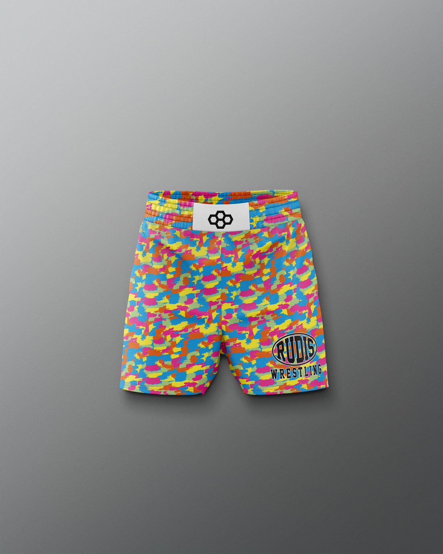 Colorful wrestling shorts with a logo on a gray background
