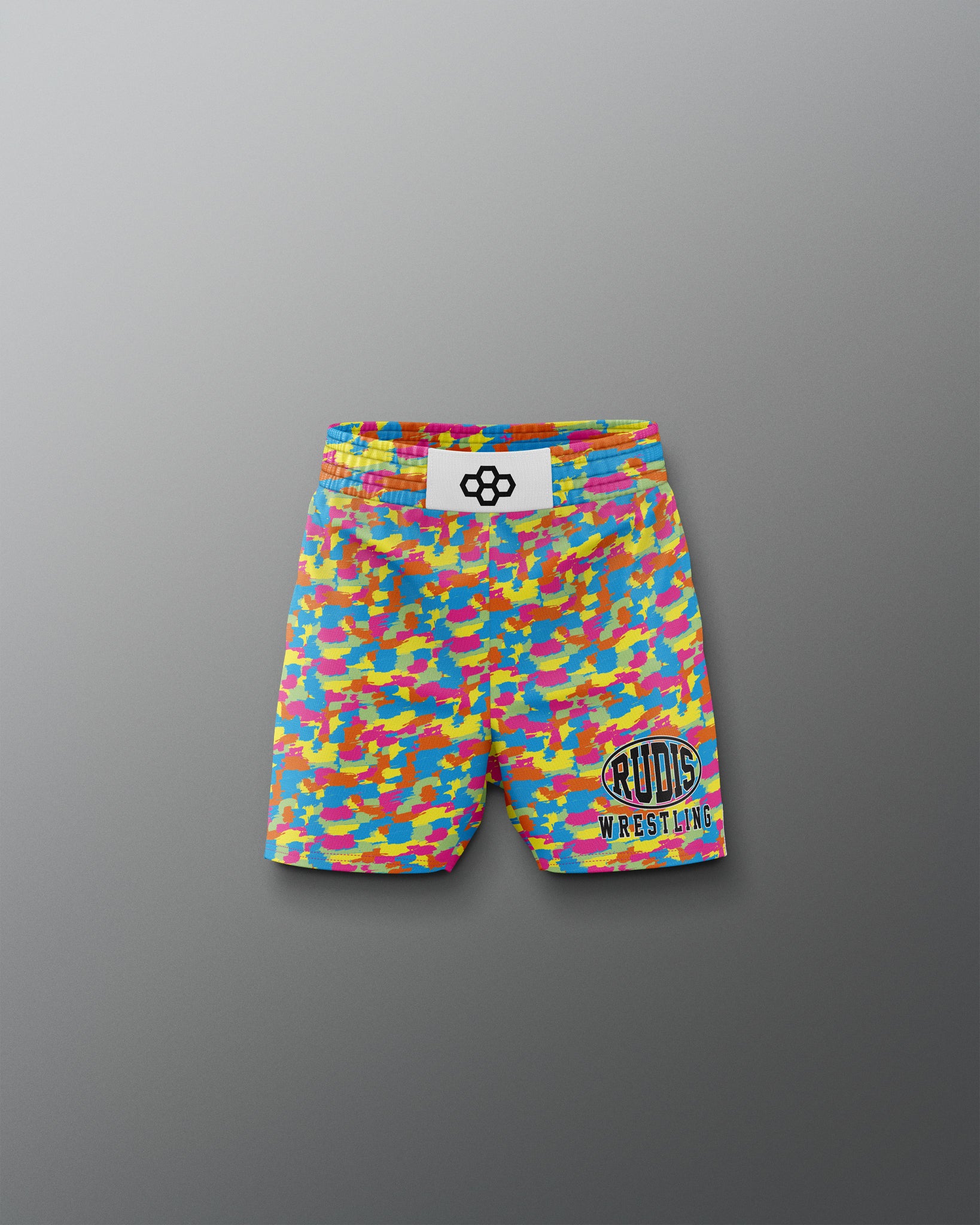 Colorful wrestling shorts with a logo on a gray background