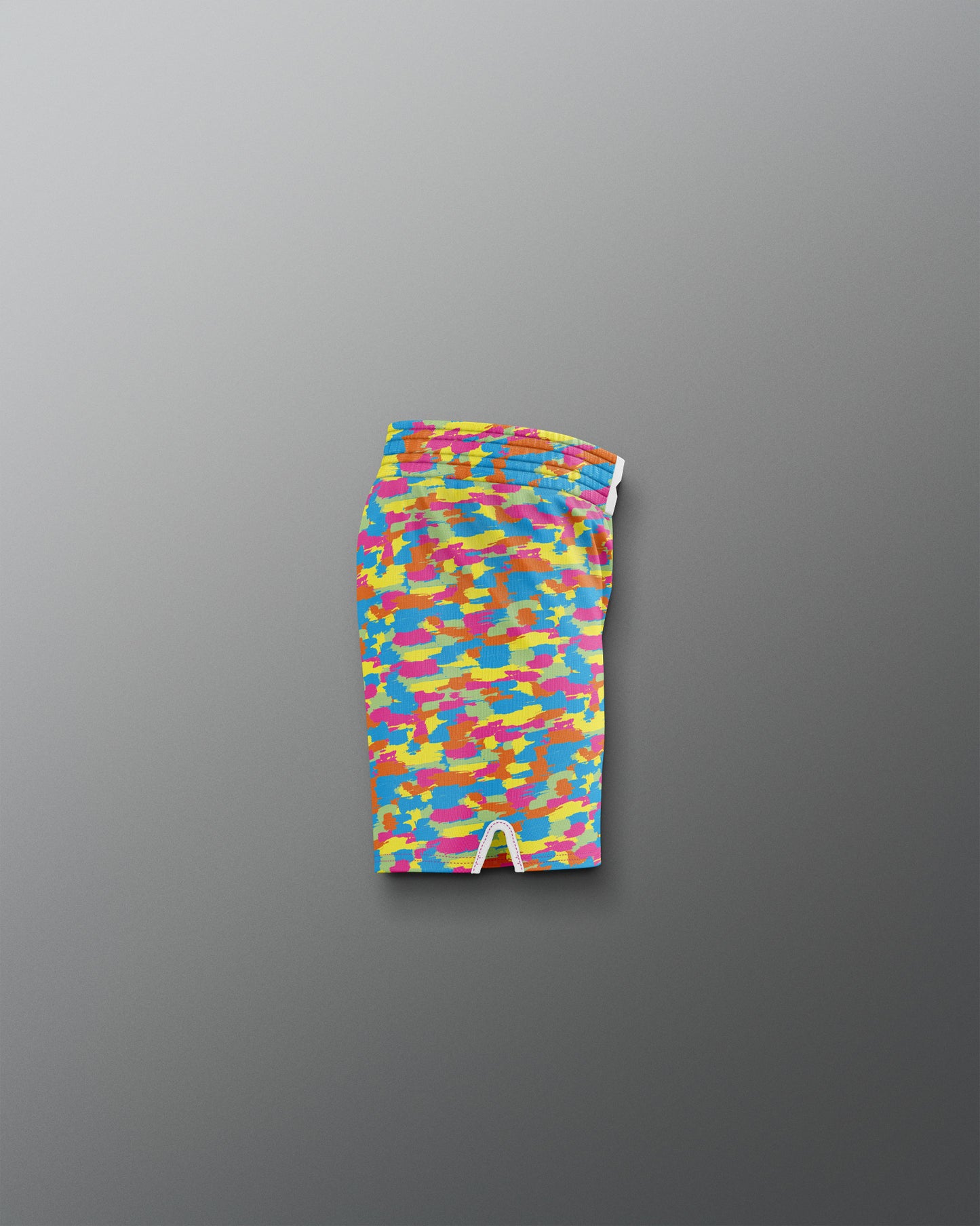 Colorful patterned swim brief on a gray background