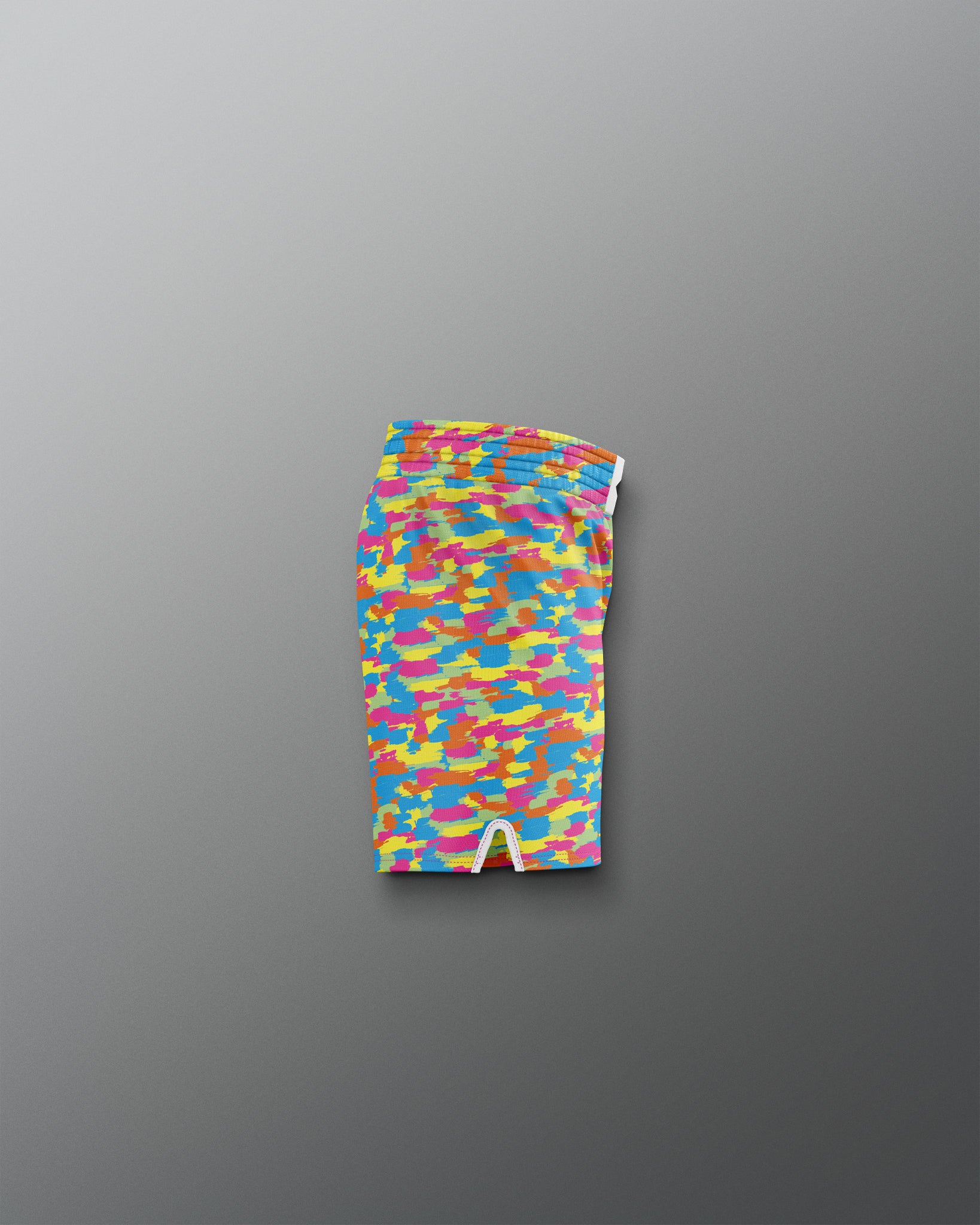 Colorful patterned swim brief on a gray background
