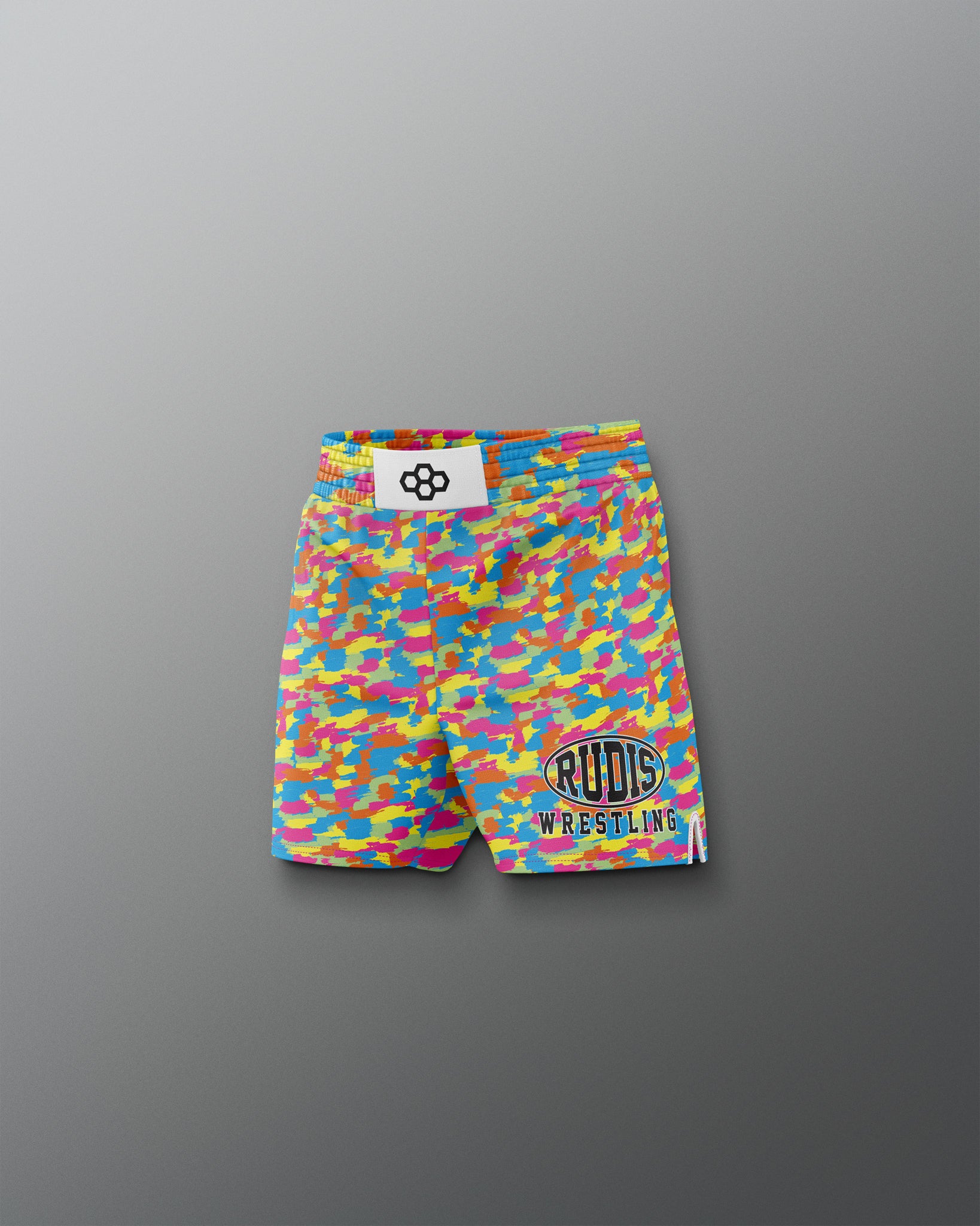 Colorful wrestling shorts with a logo on a gray background
