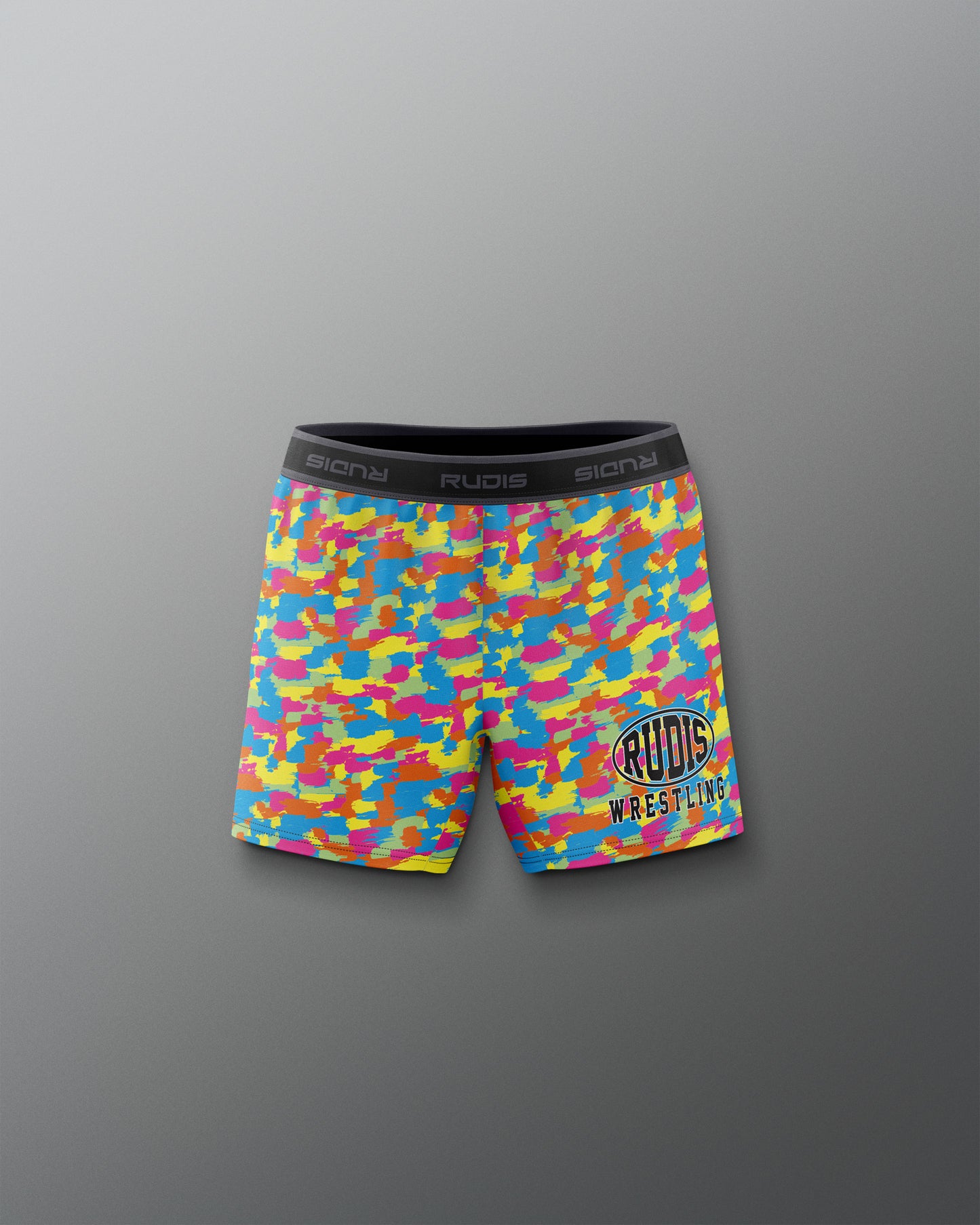 Colorful camouflage wrestling shorts with a brand logo on a gray background