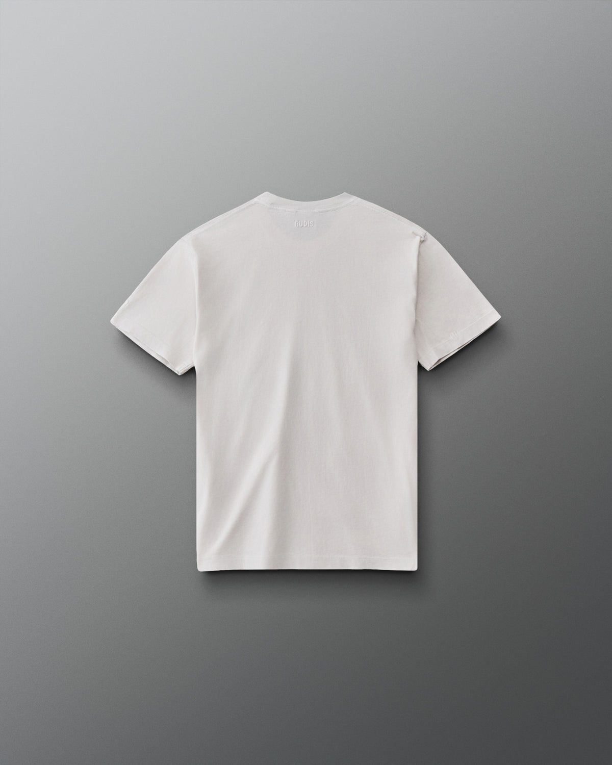 RUDIS Tilted Hex Youth Classic Cotton T-Shirt in Washed Lunar, back view showing a clean off-white design with subtle RUDIS branding below the collar.