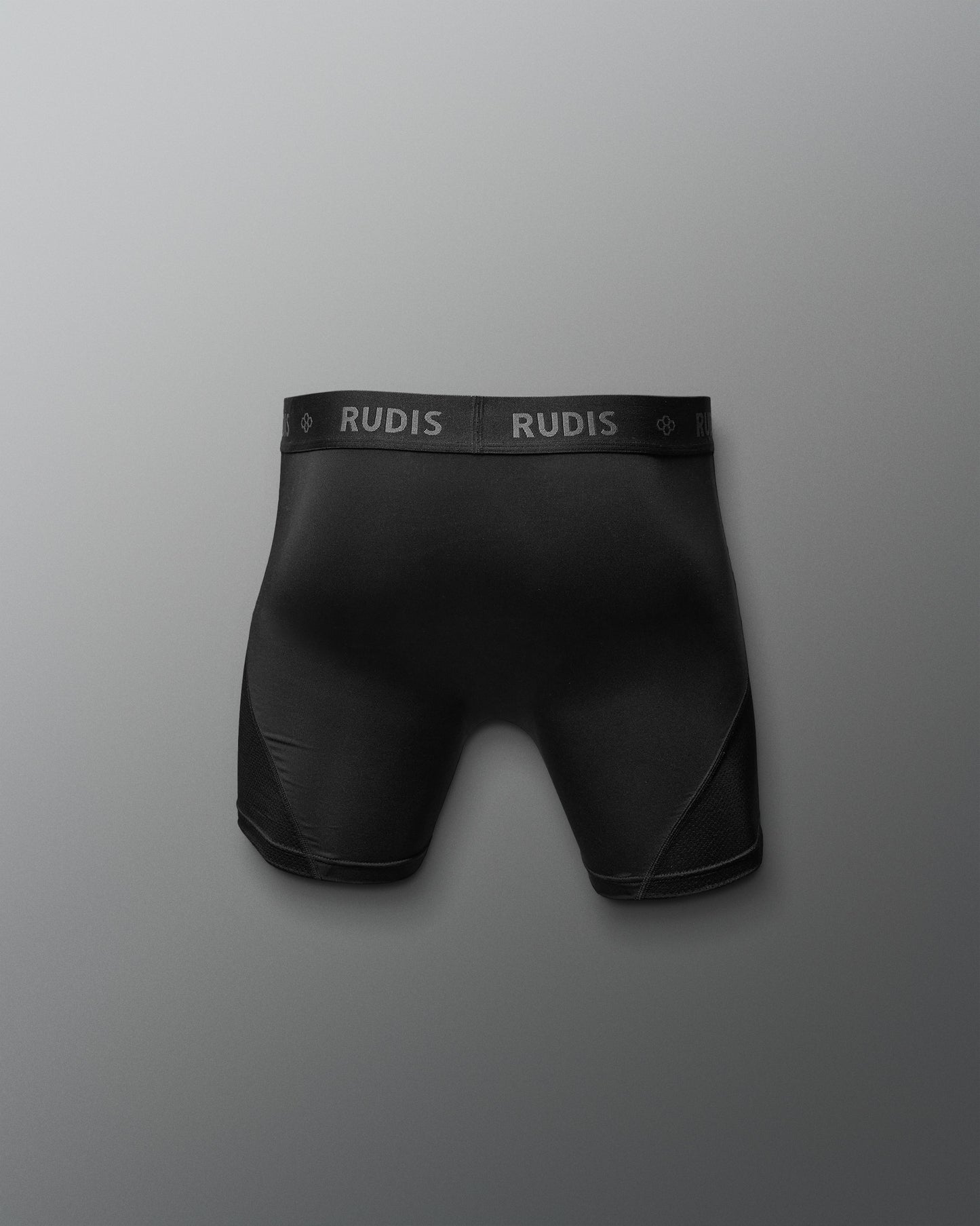 Black boxer briefs with 'RUDIS' branding on a gray background