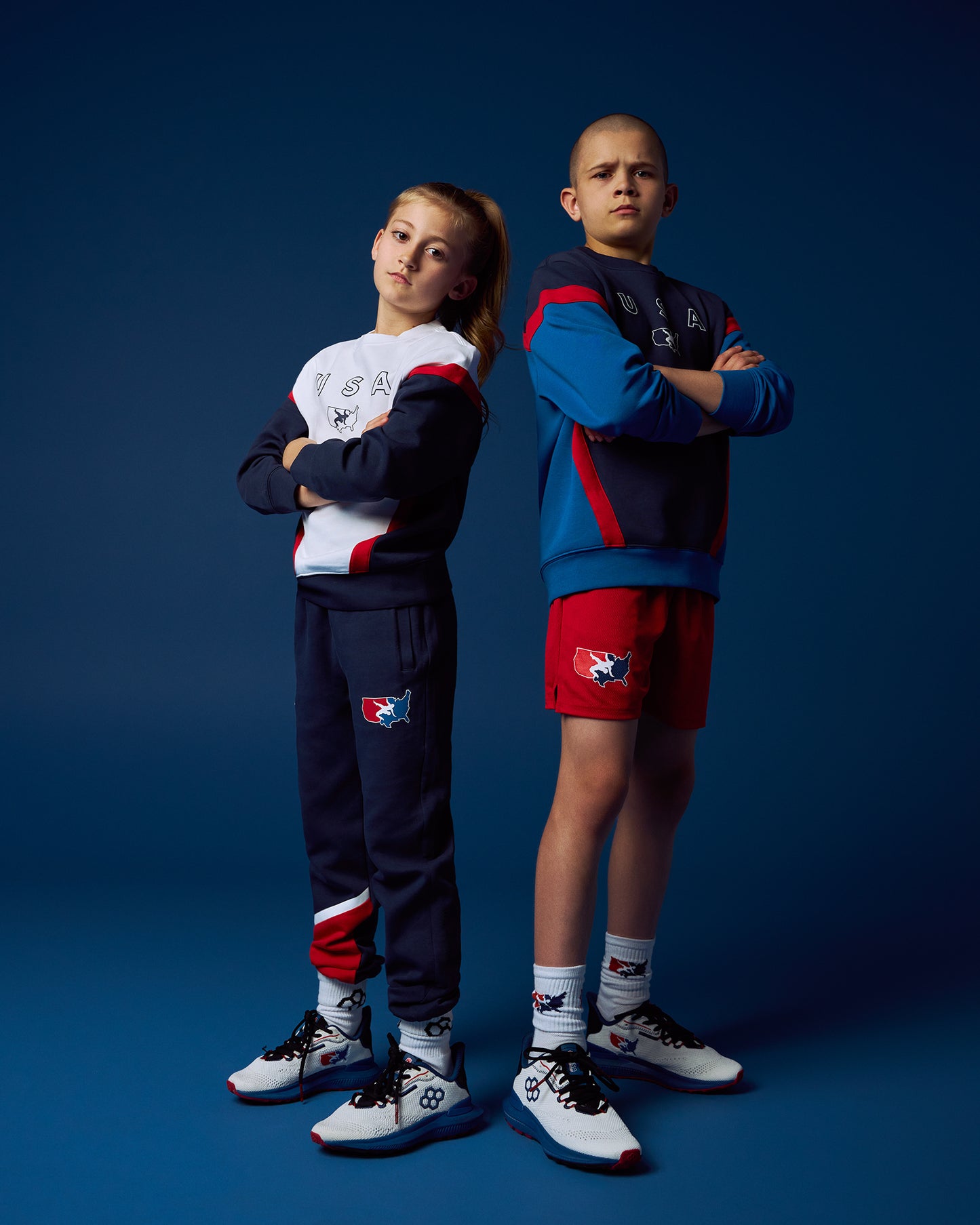 Two children wearing matching outfits with a logo on a blue background