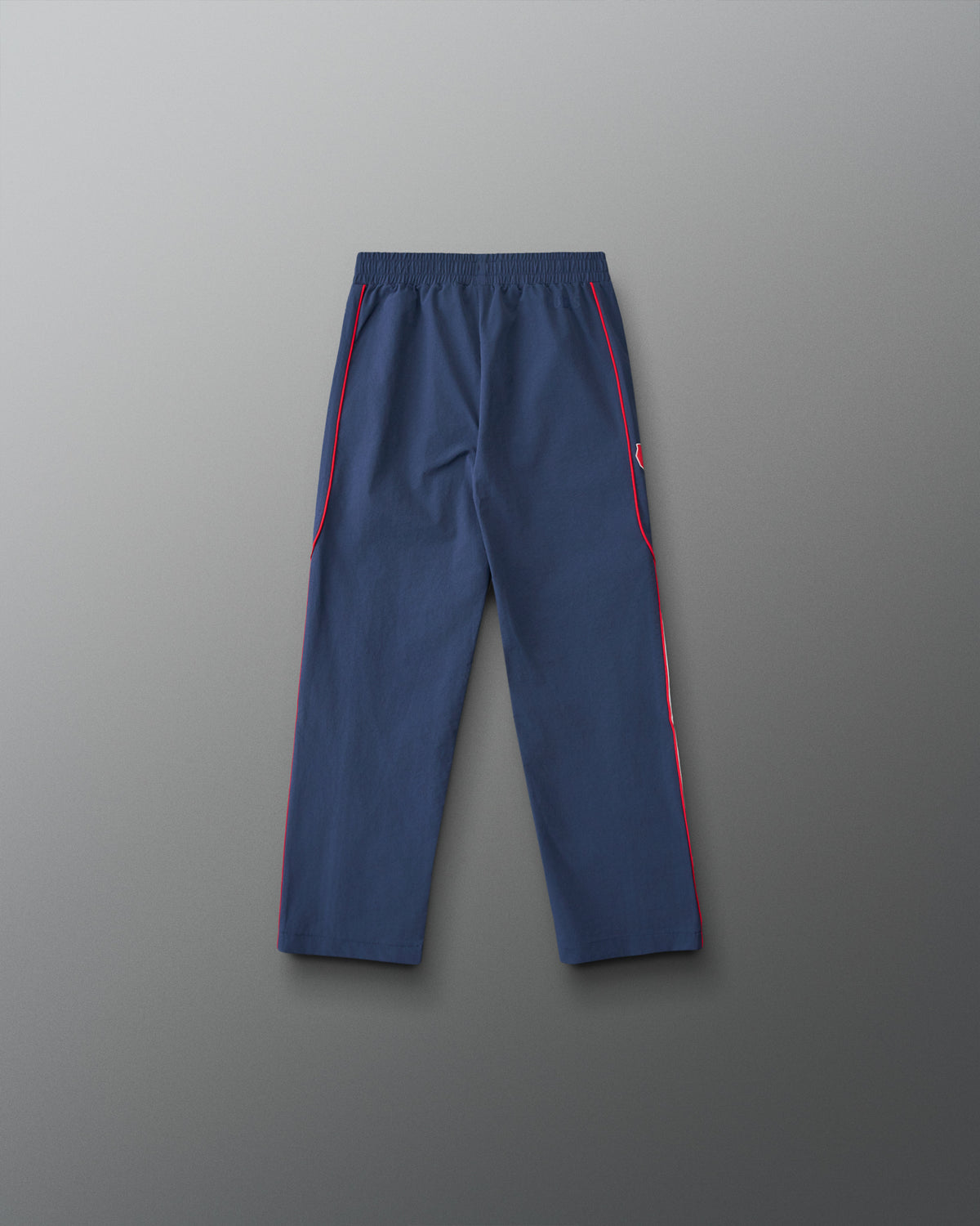 Back view of the RUDIS USA Wrestling Youth Movement Podium Pants in navy, featuring red piping, an elastic waistband, and a streamlined athletic design.