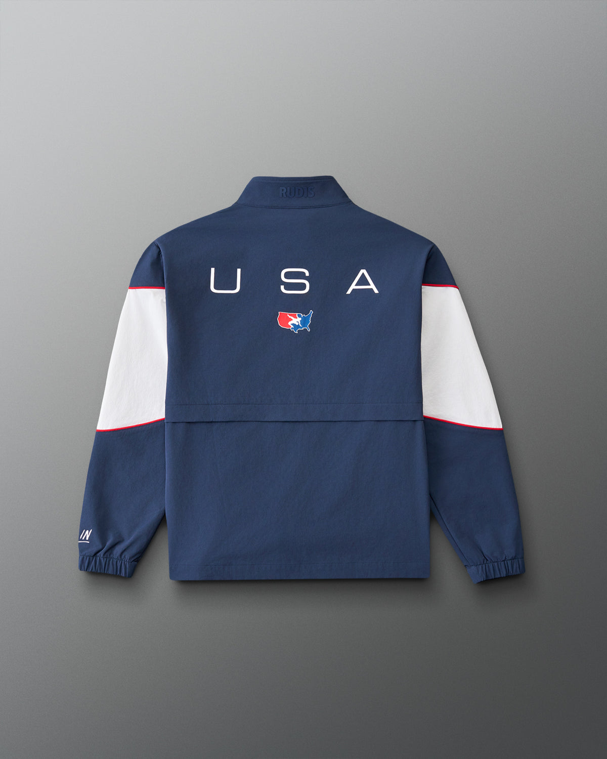 Back view of the RUDIS USA Wrestling Full Zip Movement Podium Jacket in navy, featuring large USA lettering, USA Wrestling logo, white sleeve panels, and red piping.