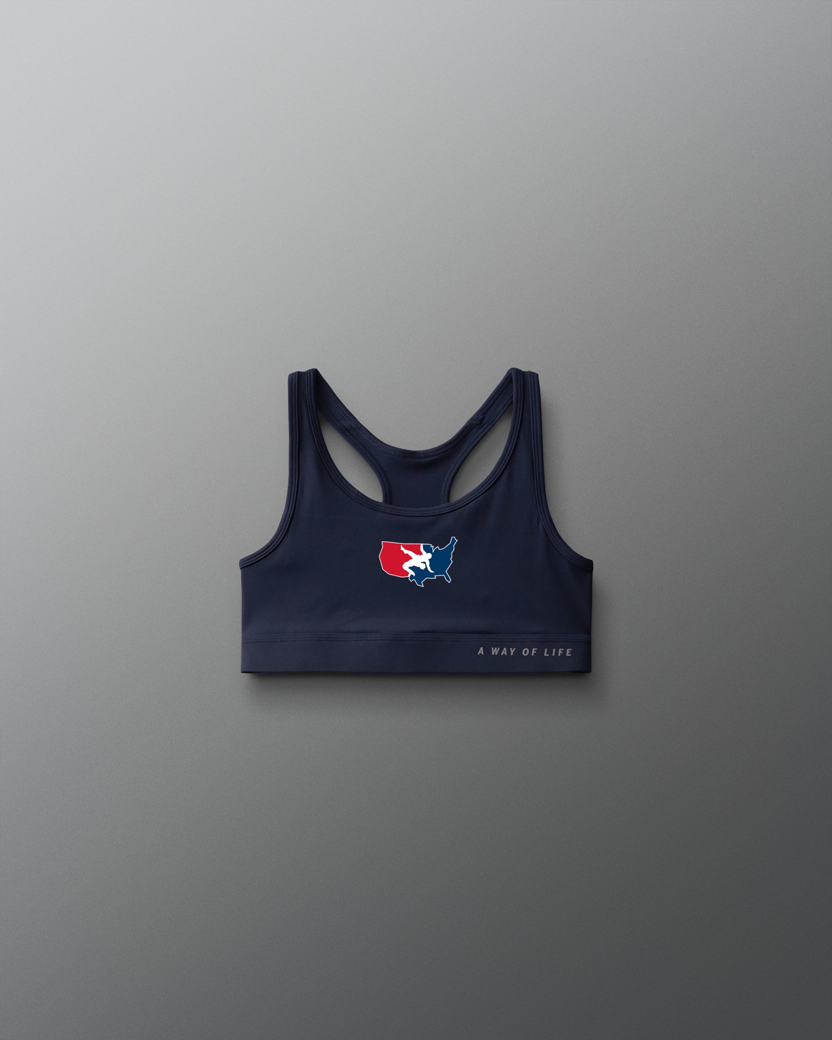 Navy sports bra with logo on a gray background