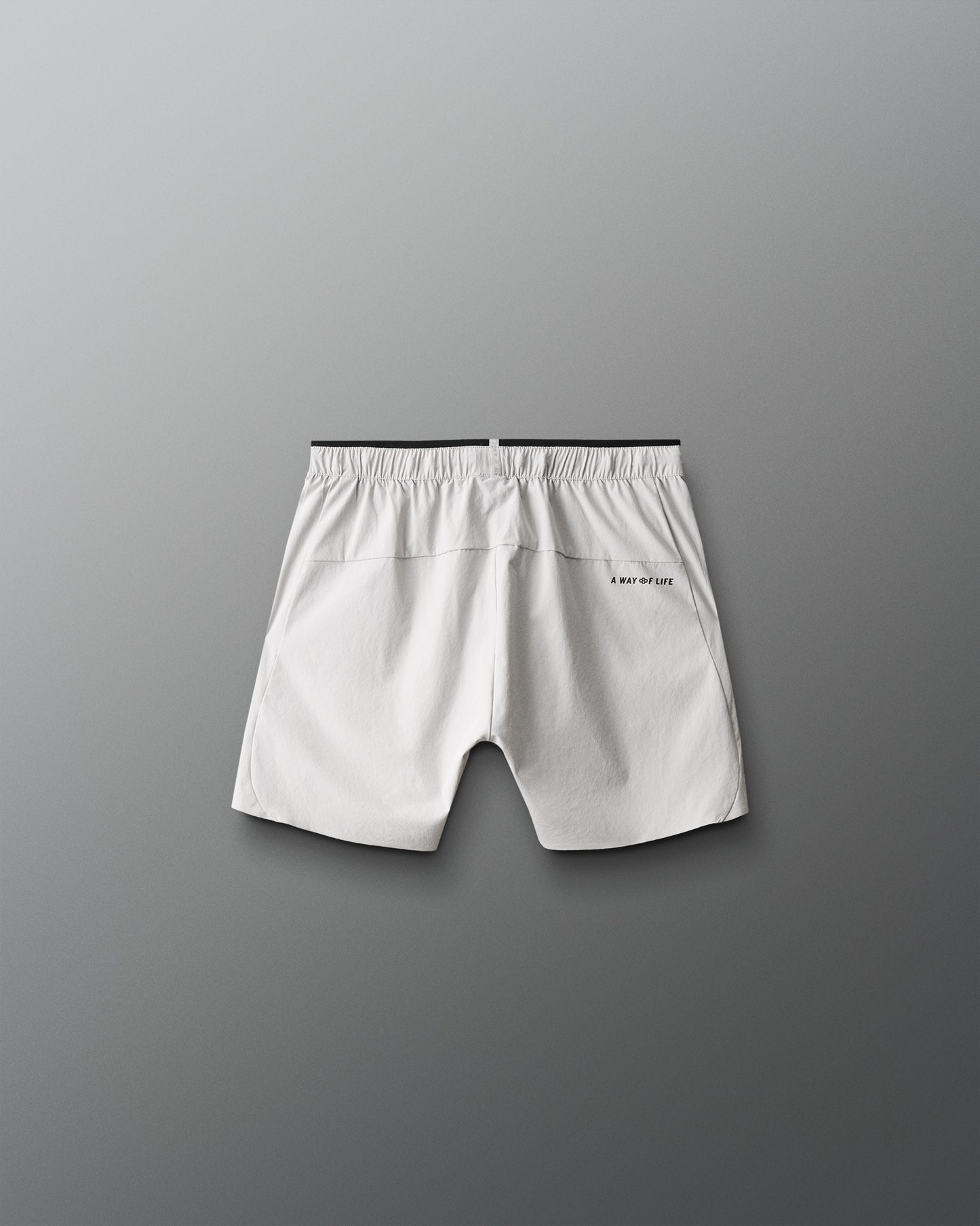 White shorts with a brand logo on a gray background