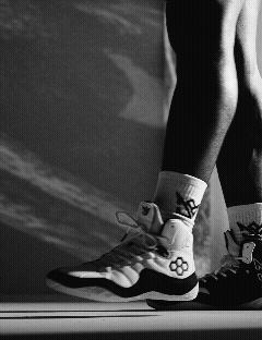 GIF of Jordan Burroughs walking in RUDIS JB1 Black Metal and White wrestling shoes. The animation shifts between close-up shots of his steps, highlighting the shoe’s bold contrast design, JB logo details, and performance-ready build. The motion emphasizes the transition from still stance to purposeful stride, underscoring Burroughs’ legacy and the power of the RUDIS JB1 wrestling shoe collection.