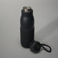 A sleek black insulated water bottle with a textured grip and a detachable lid designed for stylish hydration on the go