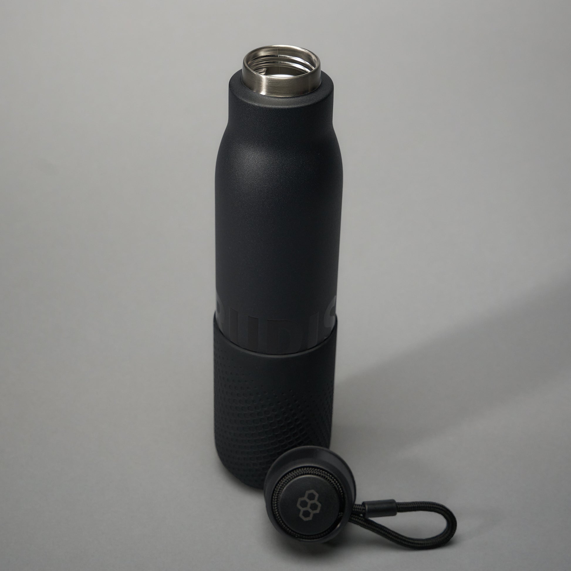 A sleek black insulated water bottle featuring a textured grip and a stainless steel opening accompanied by a detachable lid with a loop for easy carrying