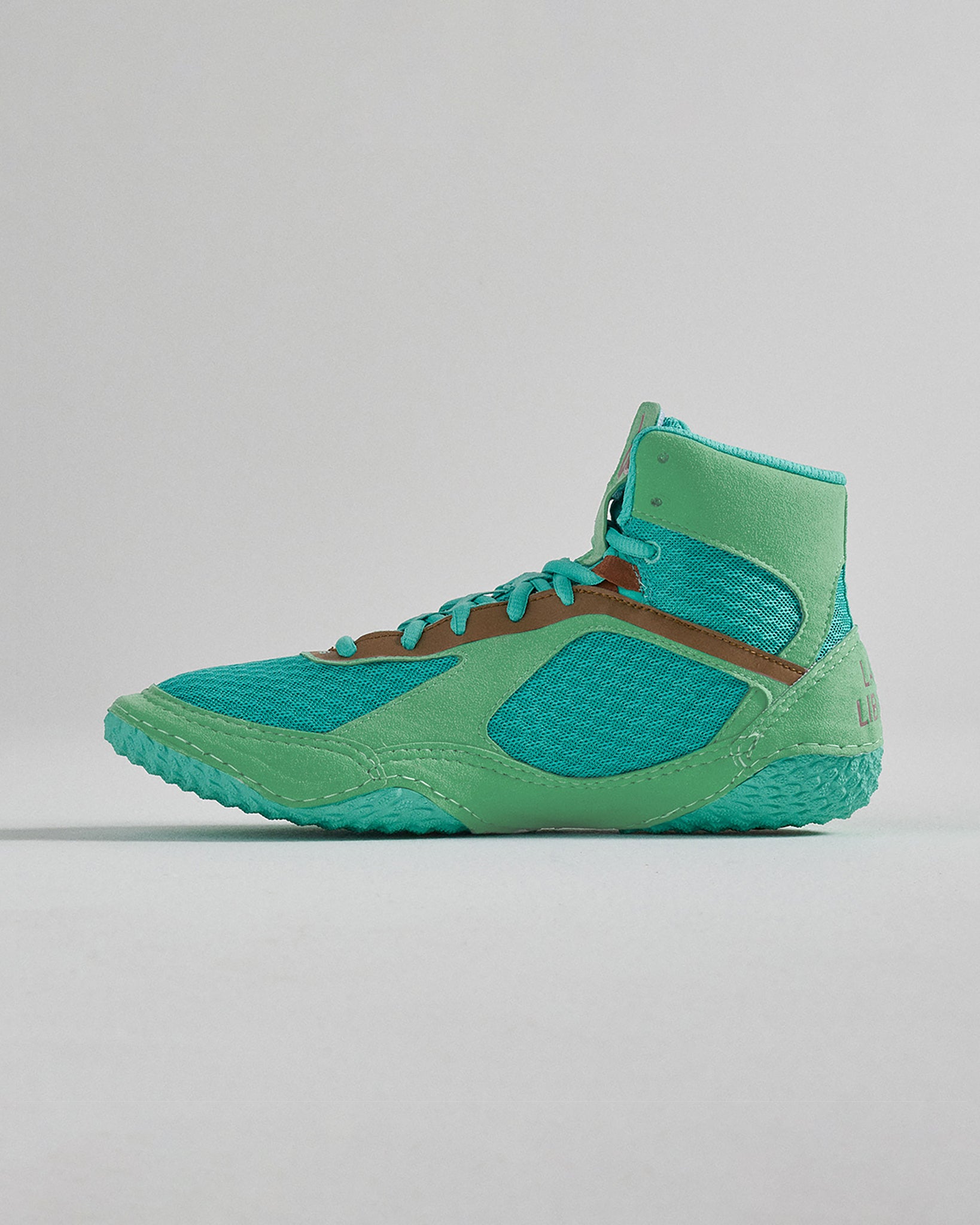 A vibrant green athletic shoe designed for performance and comfort featuring a high-top silhouette breathable mesh upper and a textured rubber sole