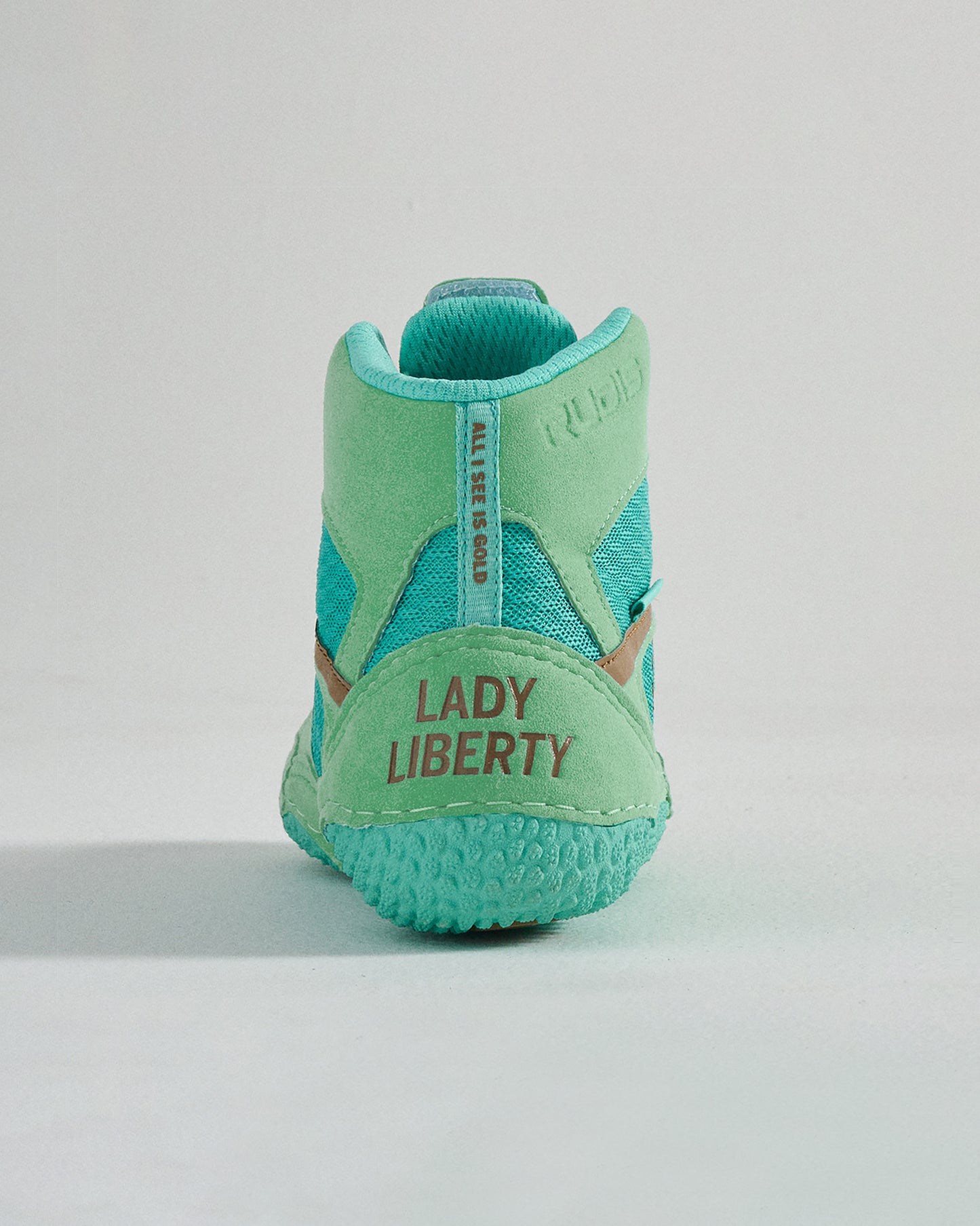 A stylish and vibrant turquoise sneaker featuring a unique Lady Liberty branding at the heel and a modern design perfect for casual wear