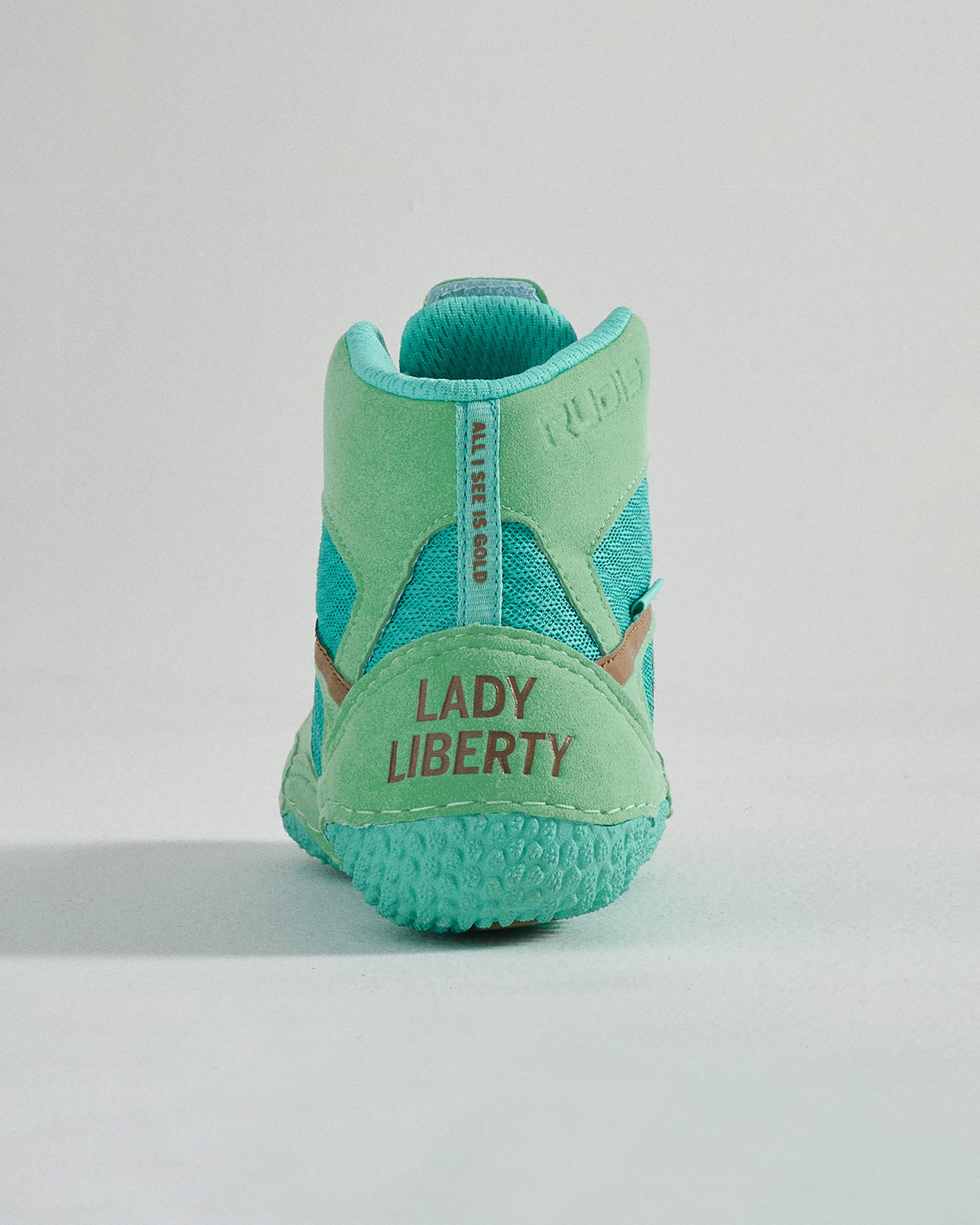 A stylish and vibrant turquoise sneaker featuring a unique Lady Liberty branding at the heel and a modern design perfect for casual wear