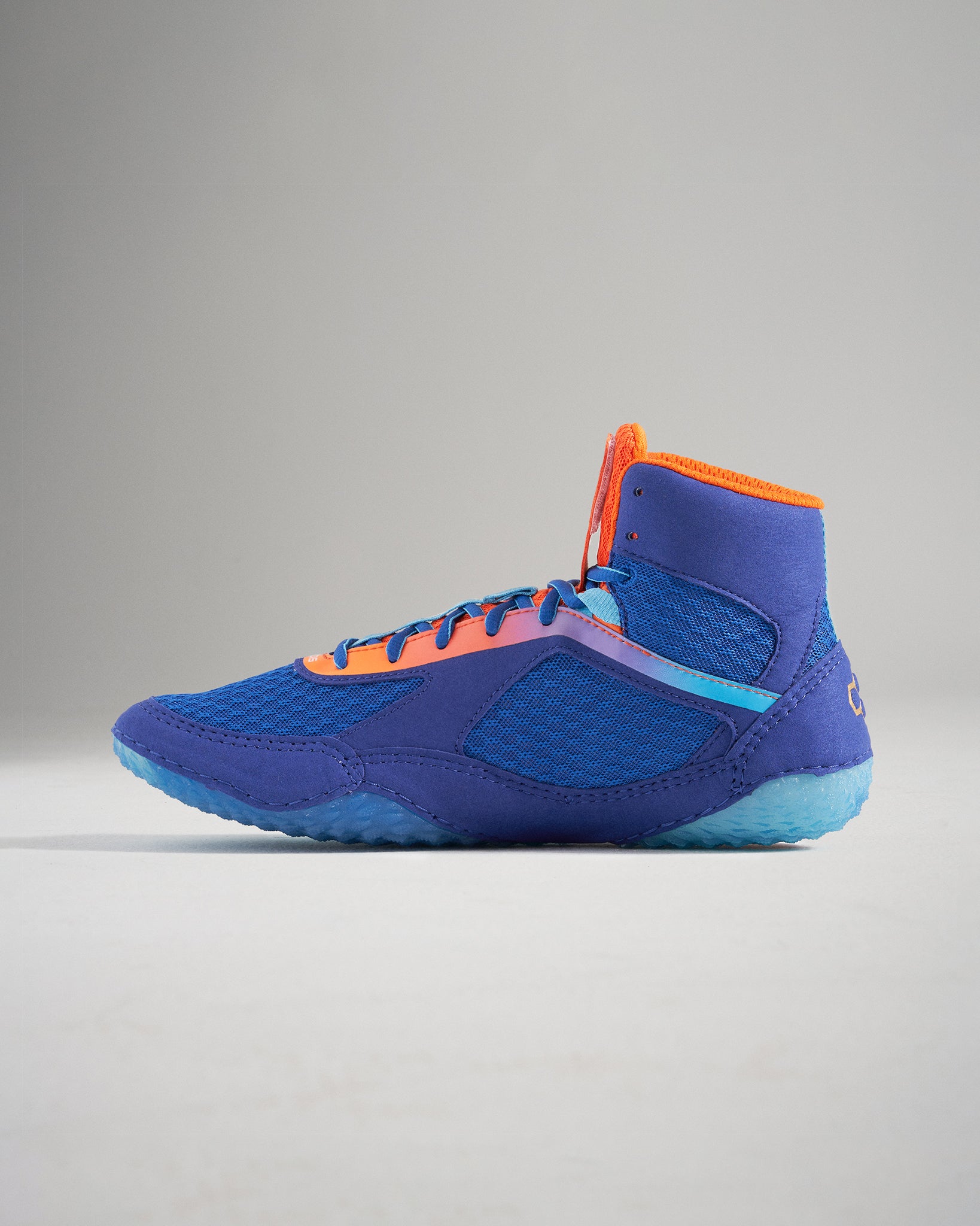 This image showcases a vibrant blue athletic shoe with orange accents and a high-top design ideal for performance and style