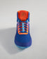 A vibrant blue athletic shoe with orange accents and a textured sole designed for maximum grip and performance