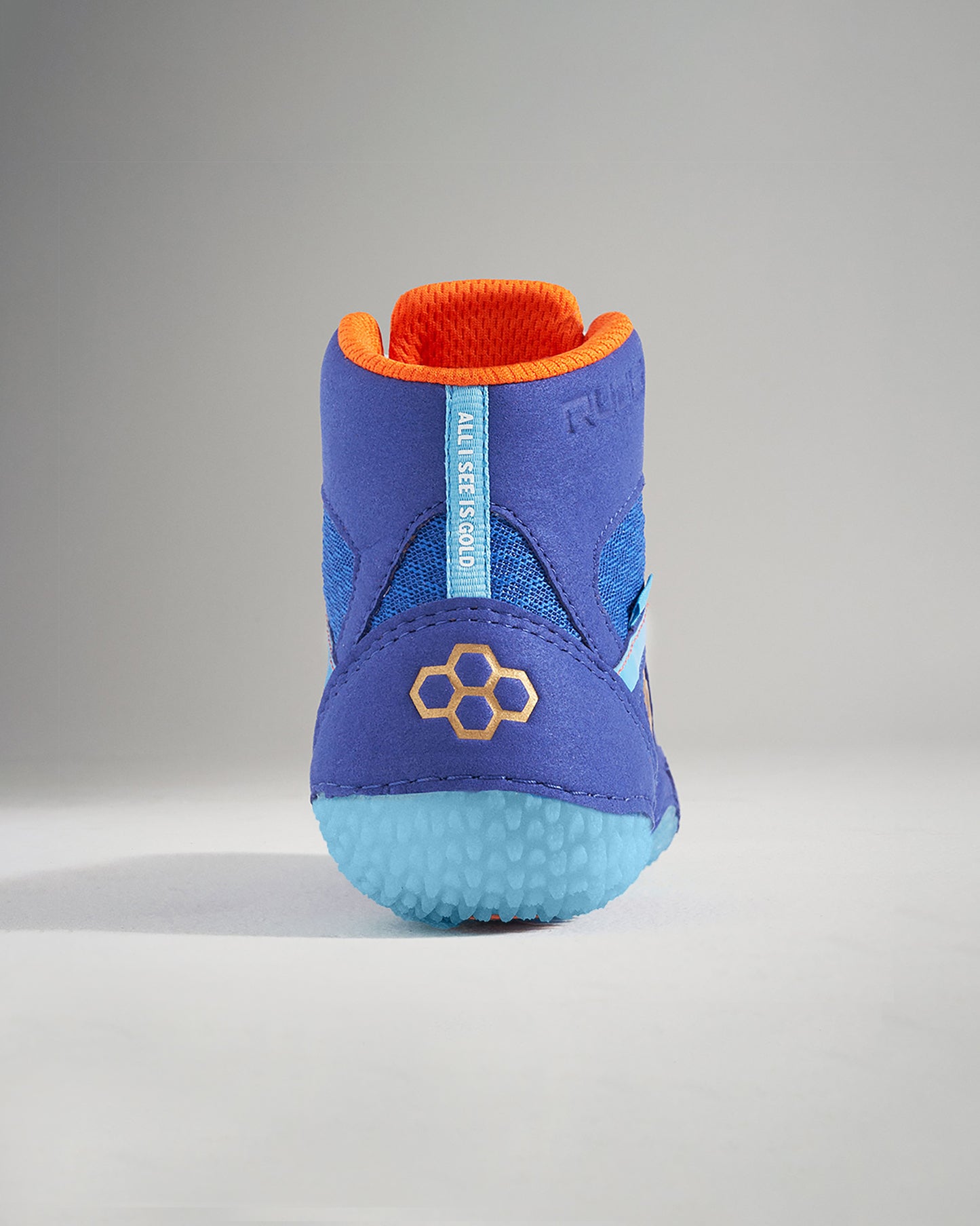 A vibrant blue athletic shoe with orange accents showcasing a unique design and textured sole for traction