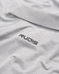 A close-up view of a light gray polo shirt featuring a black RUDIS logo on the collar area emphasizing a stylish and sporty aesthetic