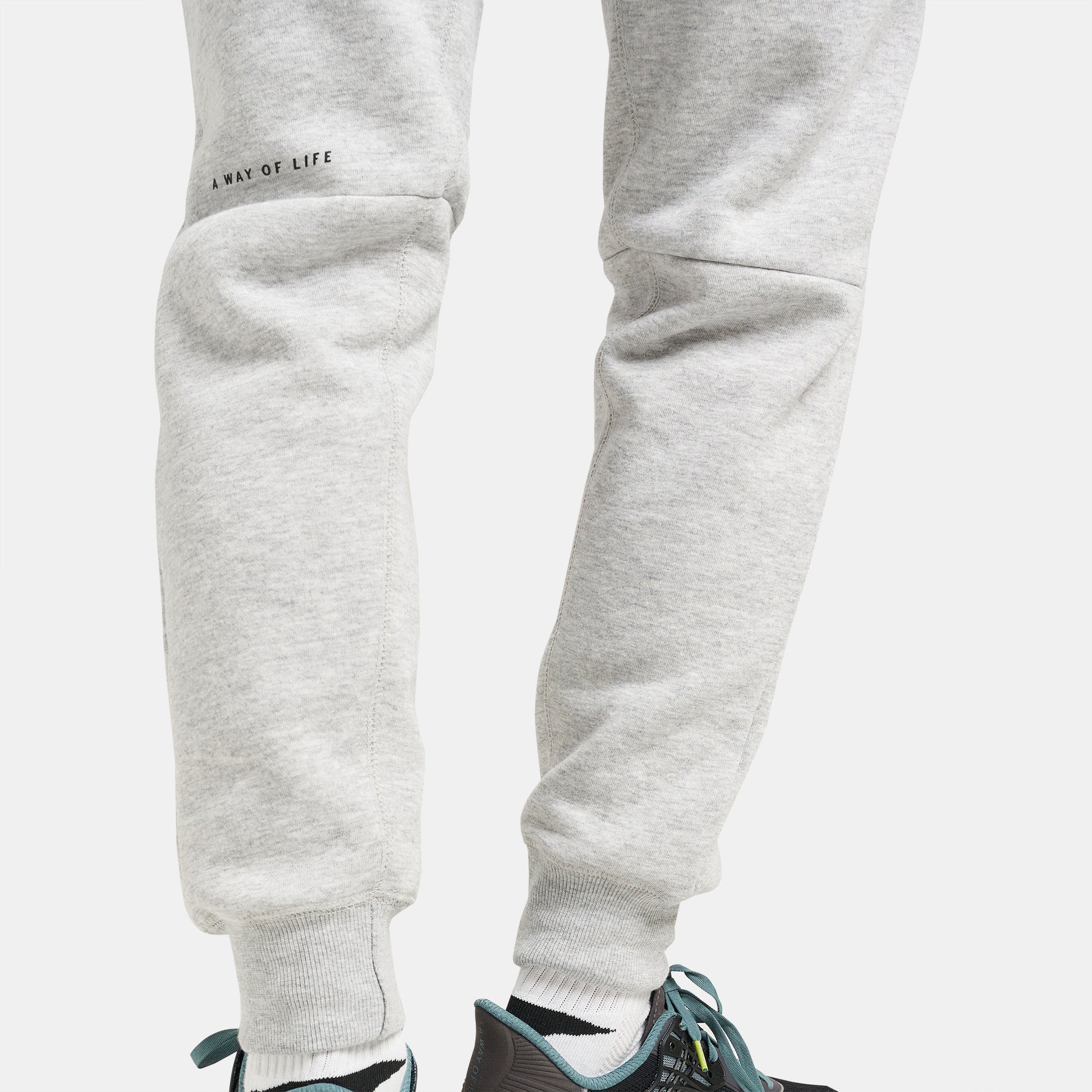 Light gray sweatpants with a snug fit and a motivational phrase designed for casual wear and comfort
