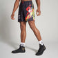 A male model showcases vibrant black athletic shorts with striking red and yellow graphics complemented by black sneakers and patterned socks