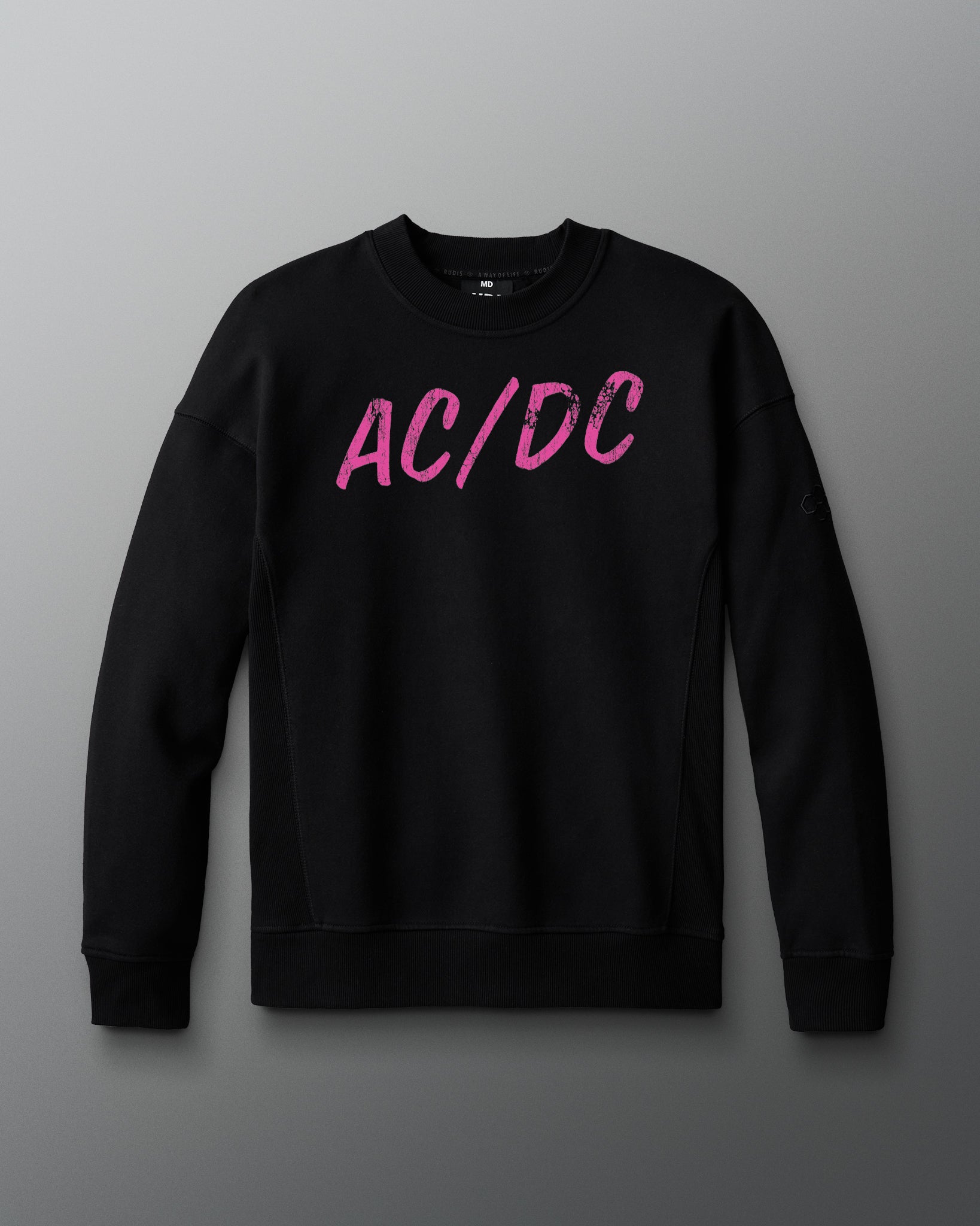 Black sweatshirt with pink 'AC/DC' logo on a gray background