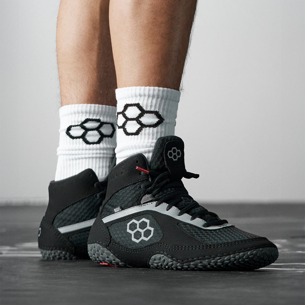 RUDIS Alpha 2.0 wrestling shoes in Darkness colorway worn on mat showcasing lightweight feel, grip traction, and secure locked-in fit