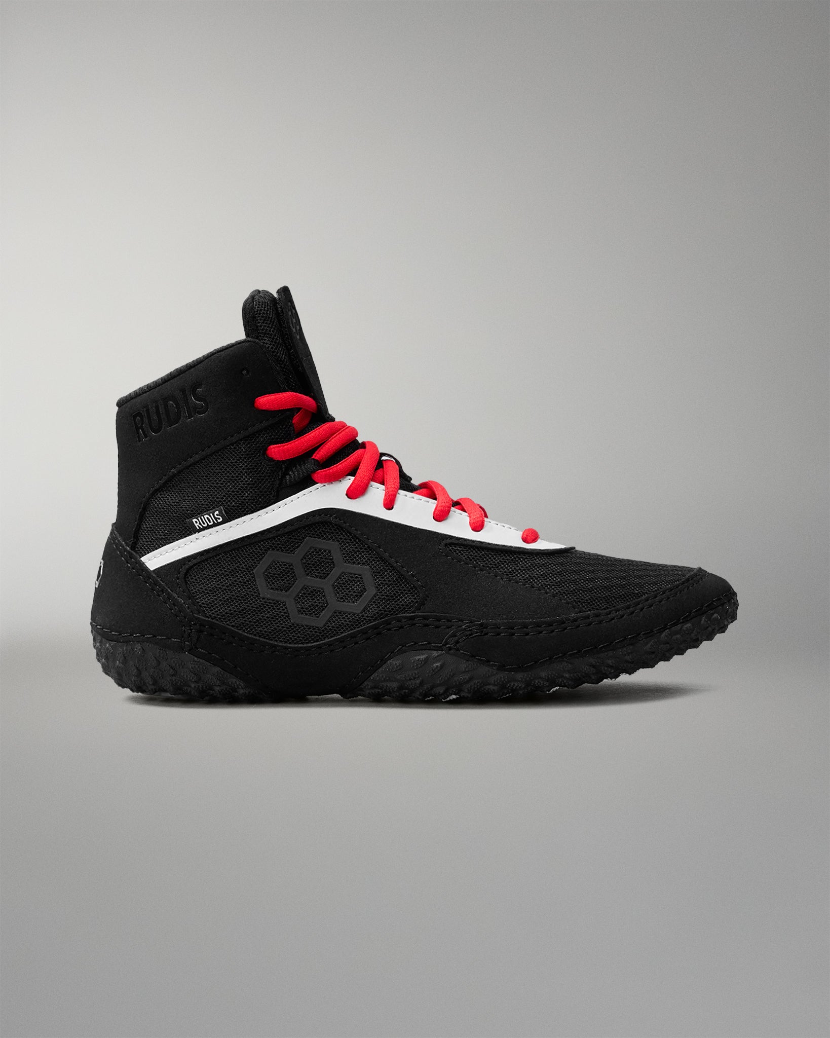 Black wrestling shoe with red laces on a gray background