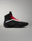 Black wrestling shoe with red laces on a gray background