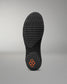 Black sole of a wrestling shoe with a textured pattern on a gray background