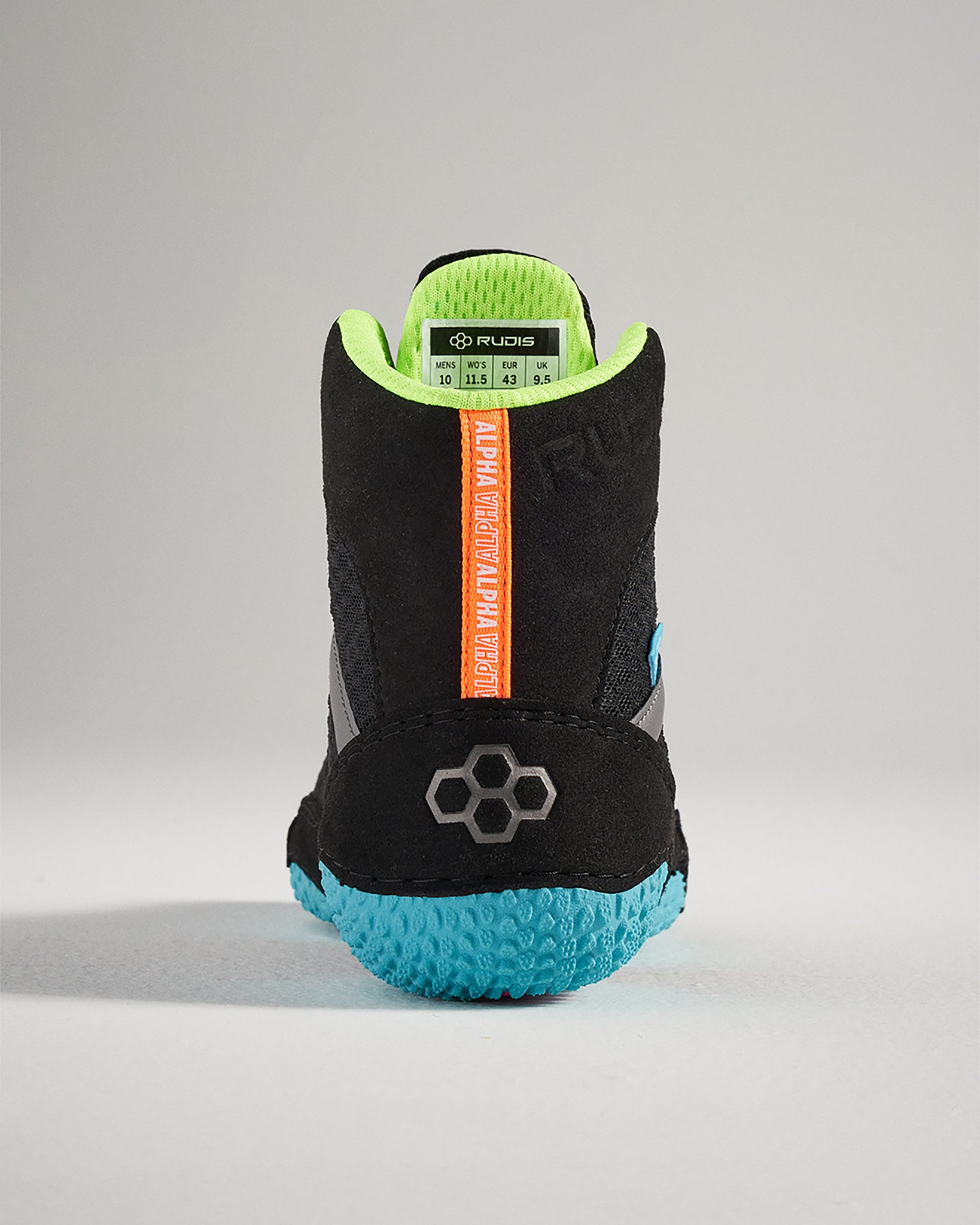 A back view of a black athletic shoe featuring a textured blue sole bright green lining and vibrant orange branding showcasing modern design elements for optimal performance