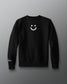 Black sweatshirt with a smiley face design on a gray background