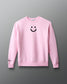 Pink sweatshirt with a smiley face design on a gray background