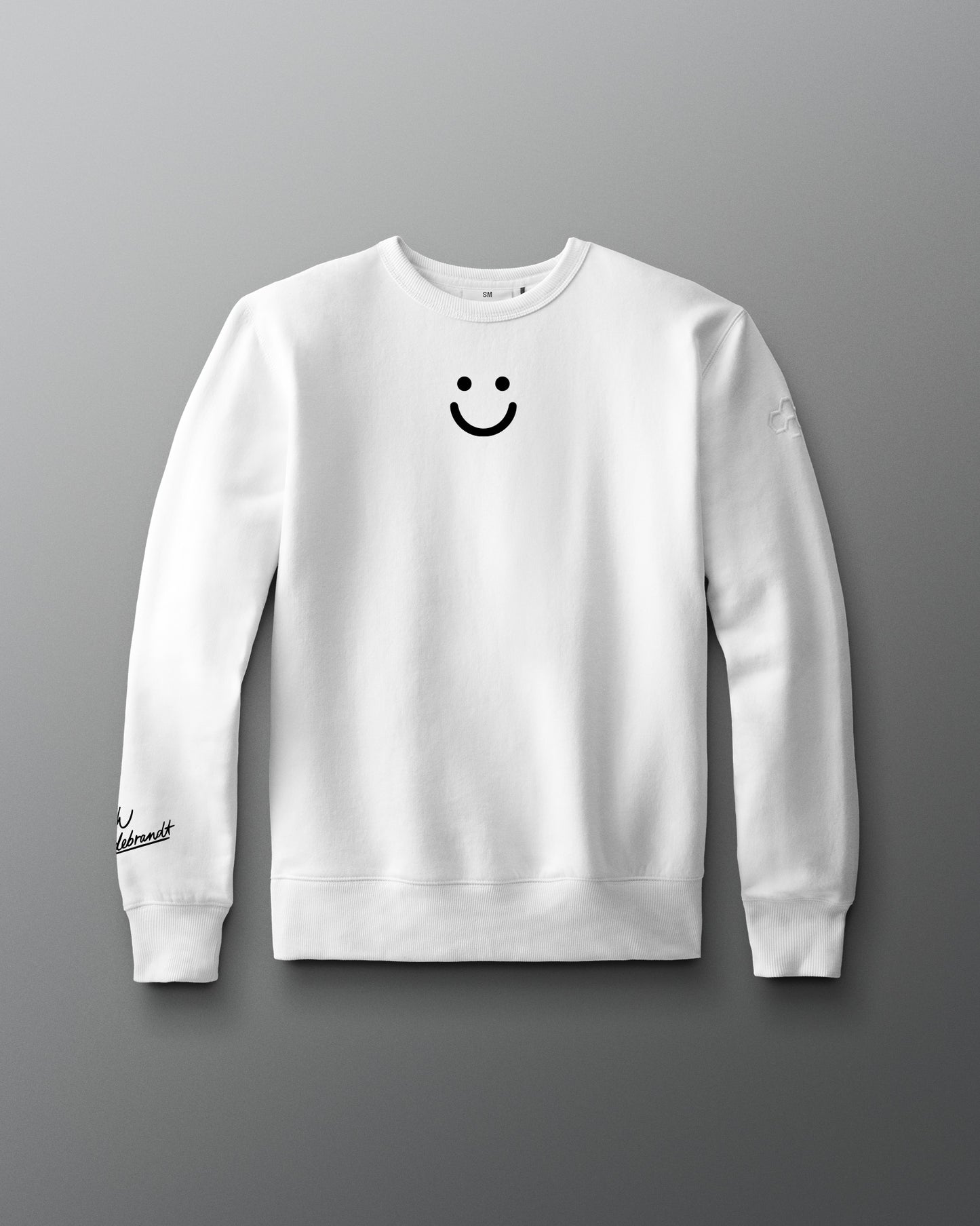 White sweatshirt with a smiley face design on a gray background