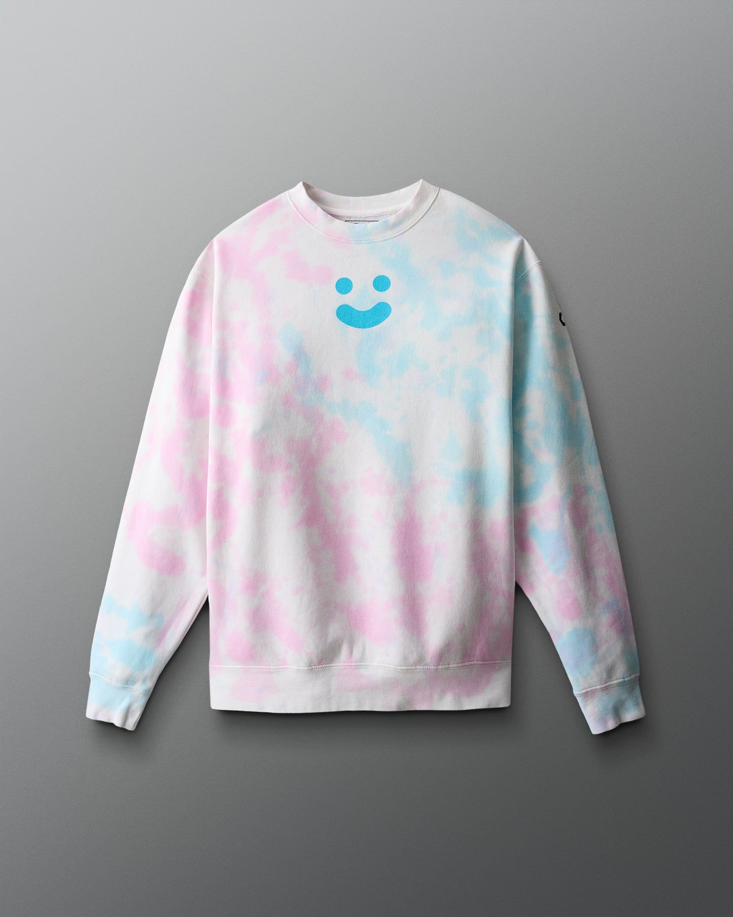 Tie-dye sweatshirt with a smiley face design on a gray background