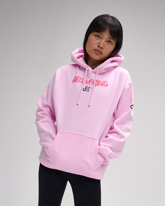 Person wearing a pink hoodie with text on a gray background