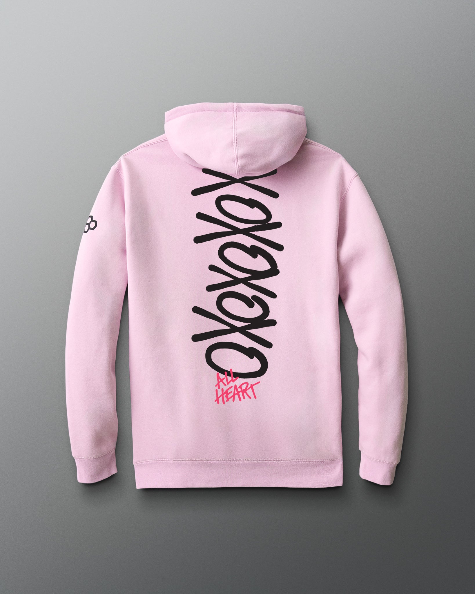 Pink hoodie with black and red text on the back against a gray background
