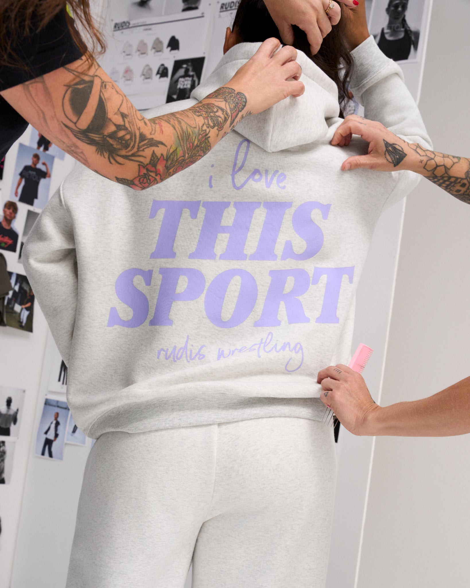 Behind-the-scenes back view of the RUDIS Love This Sport Relaxed Comfort Fleece Hoodie in Heather Silver, featuring a lavender wrestling graphic.