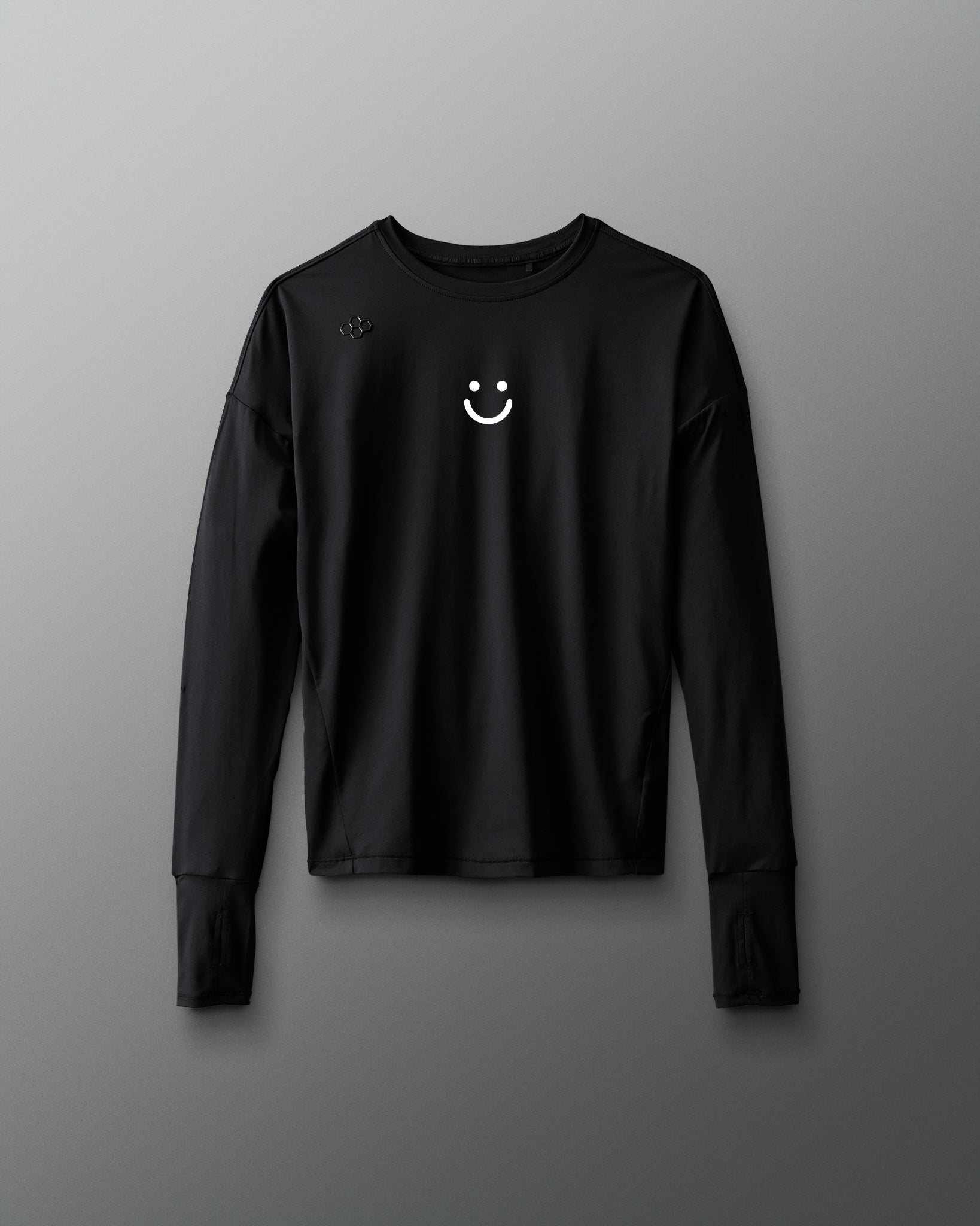 Black long-sleeve shirt with a smiley face emblem on a gray background