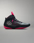 Black and pink wrestling shoe on a gray background