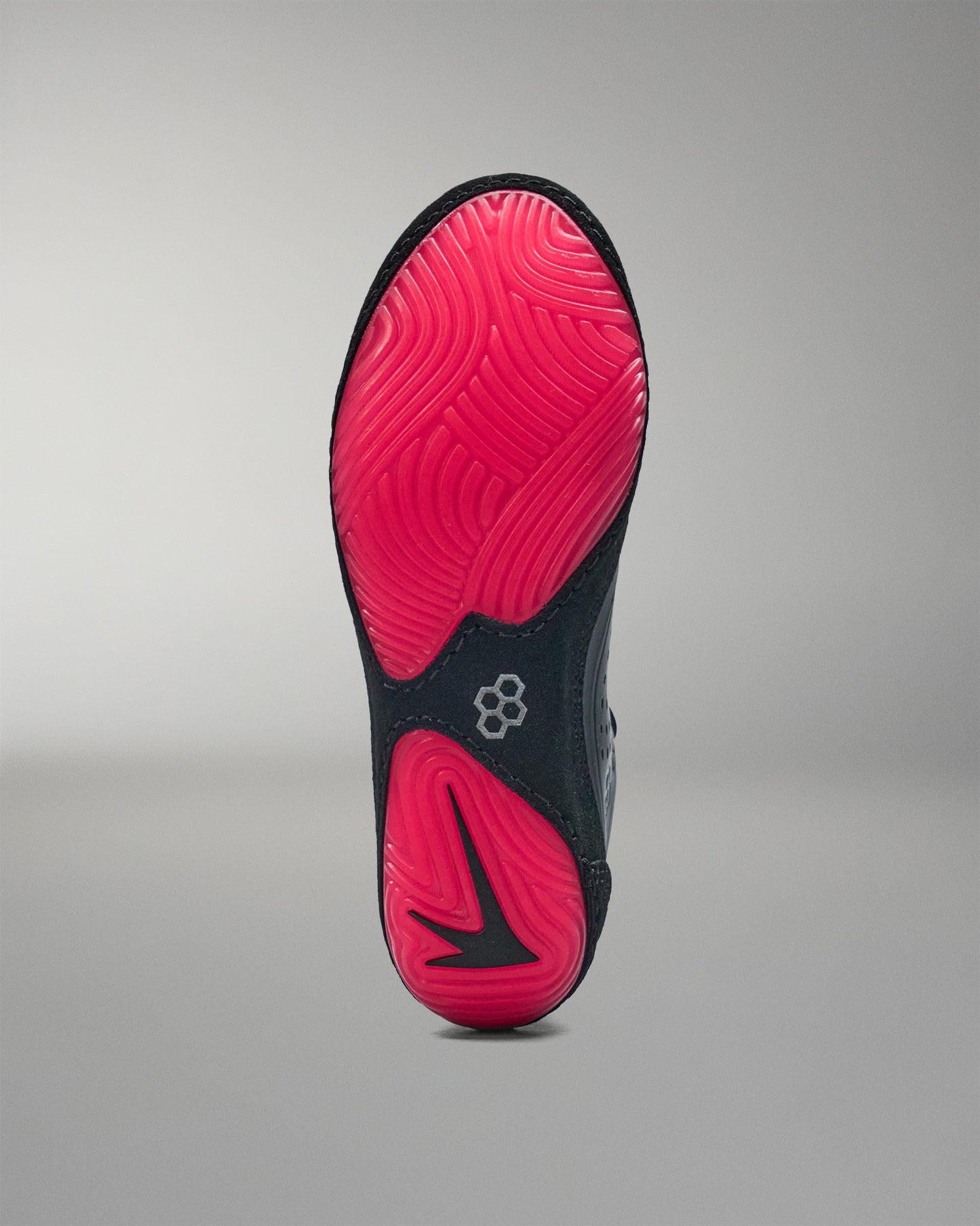 Black and pink wrestling shoe sole on a gray background