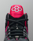 Black and pink wrestling shoe with a prominent RUDIS brand logo on a gray background