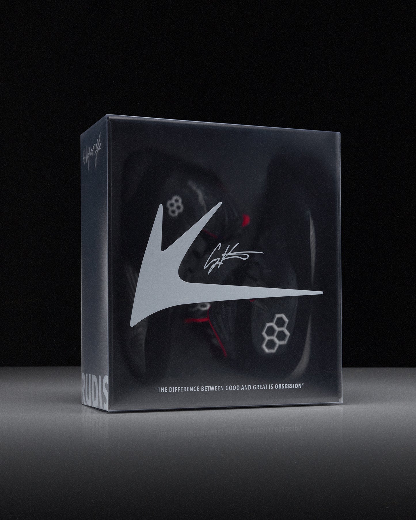 Box with a wrestling shoe and 'RUDIS' brand logo on a black background - Cary Kolat wrestling shoes