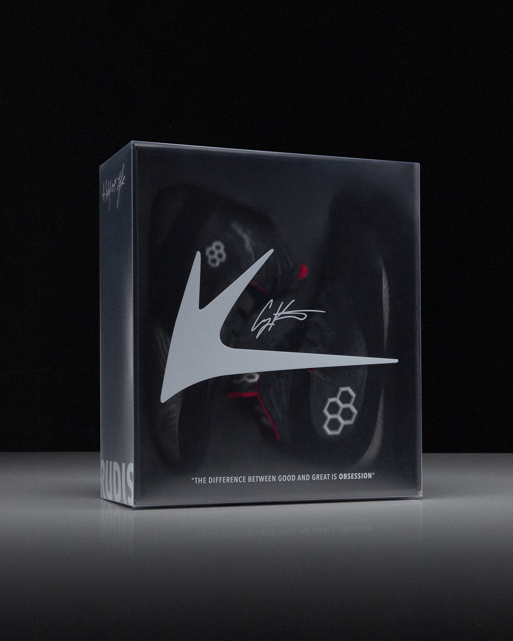 Box with a wrestling shoe and 'RUDIS' brand logo on a black background - Cary Kolat wrestling shoes