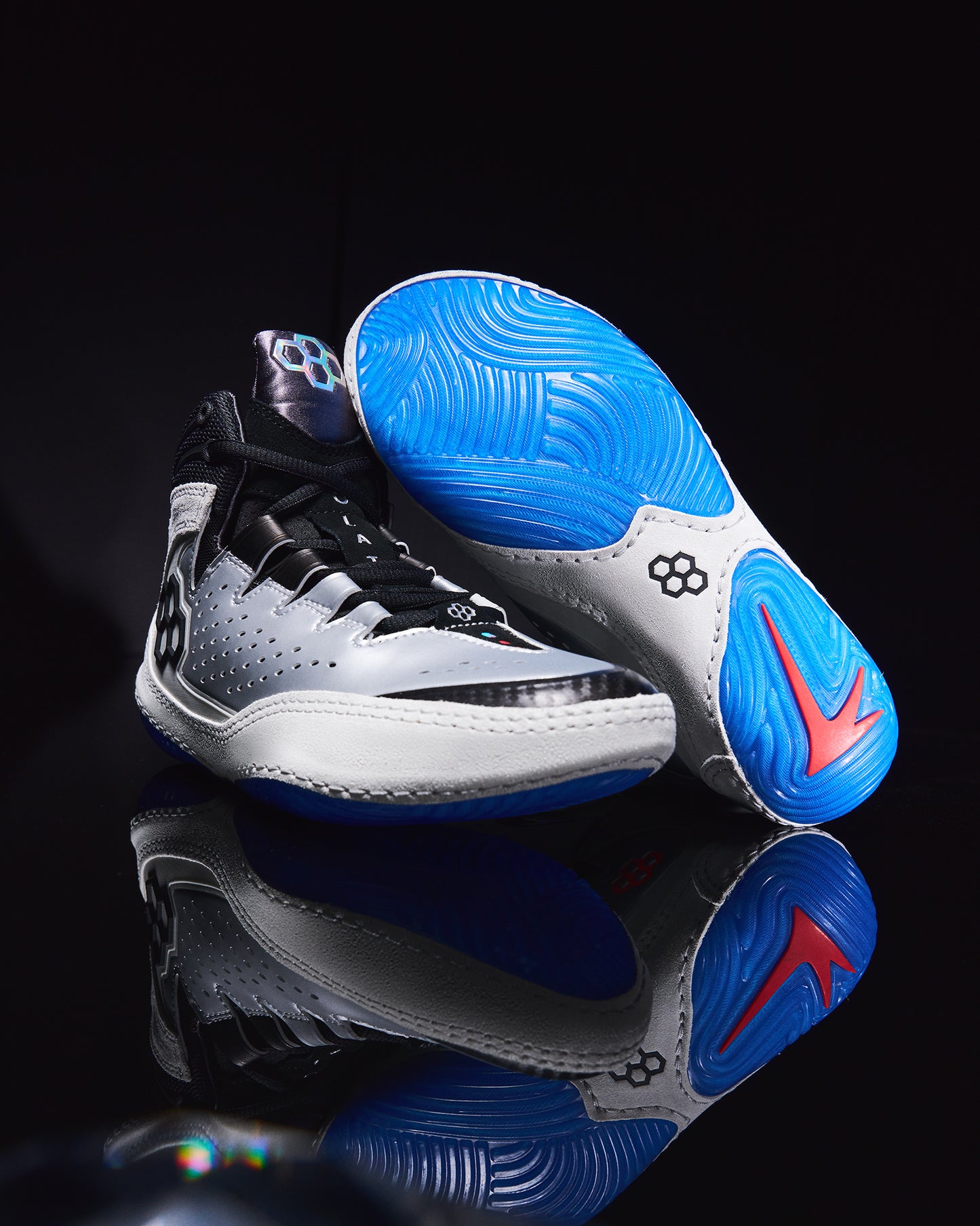 wrestling shoes with blue and white sole on a black background