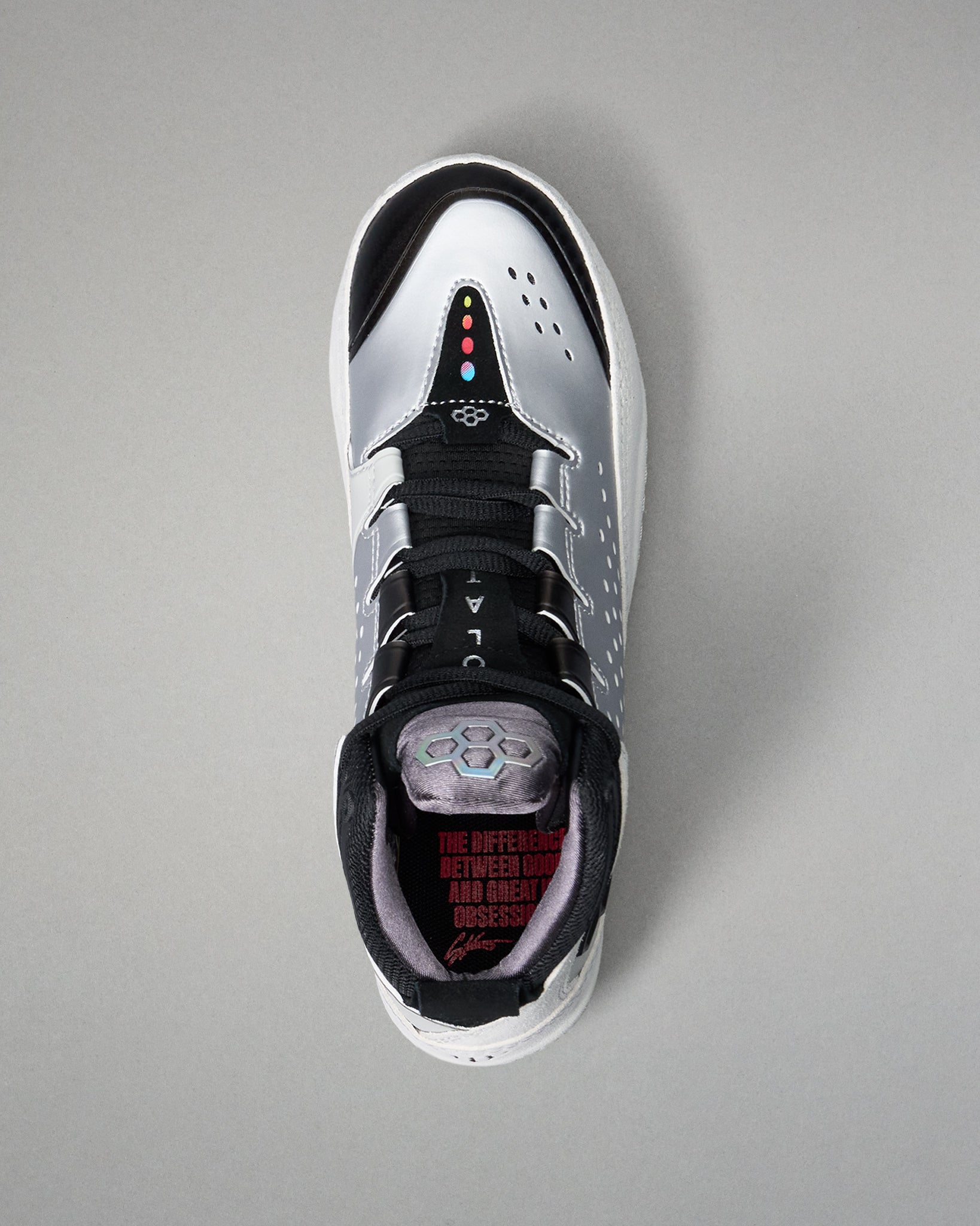 Black and white wrestling shoe on a gray background