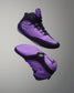 Purple and black wrestling shoes on a gray background