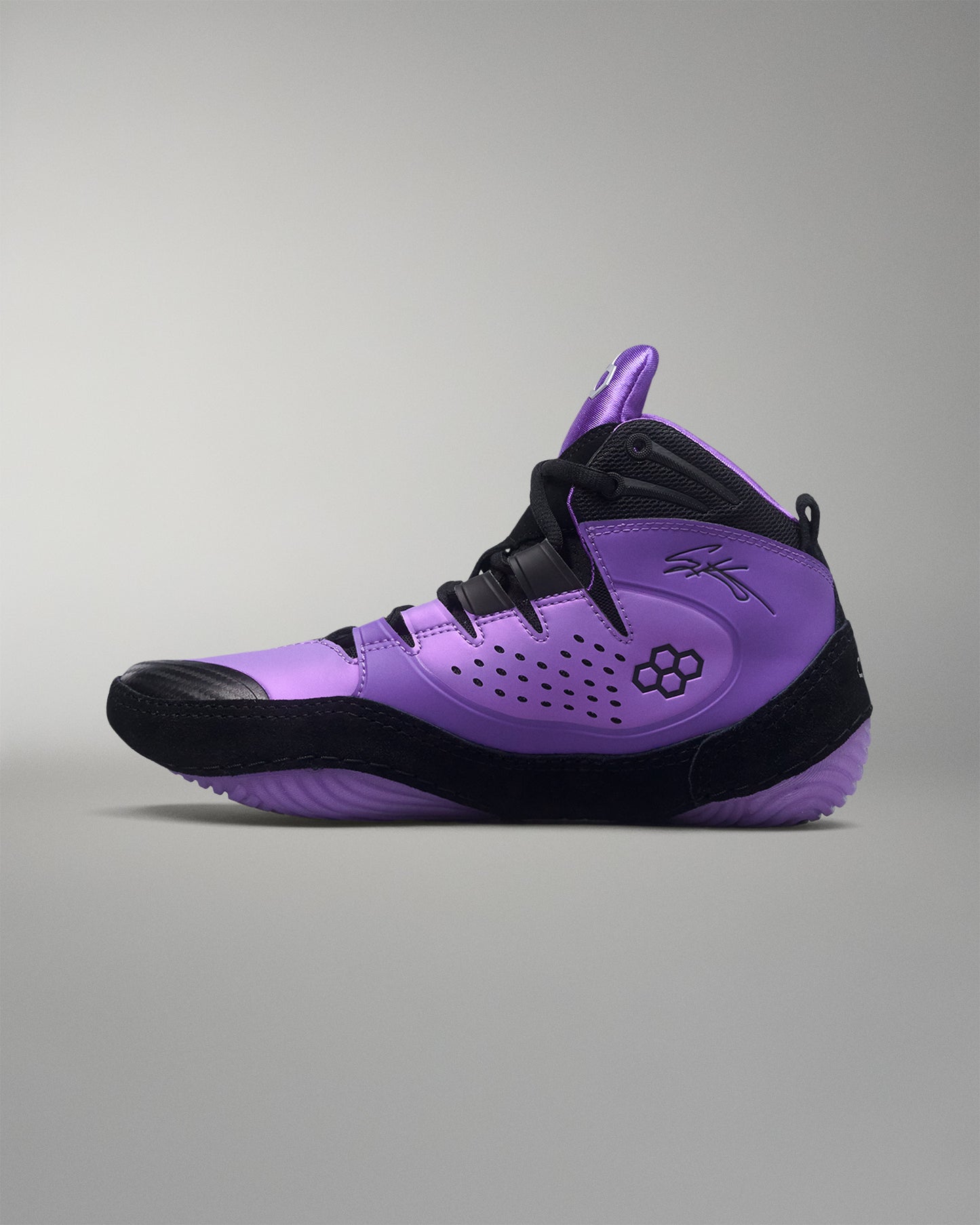 Purple and black wrestling shoe on a gray background
